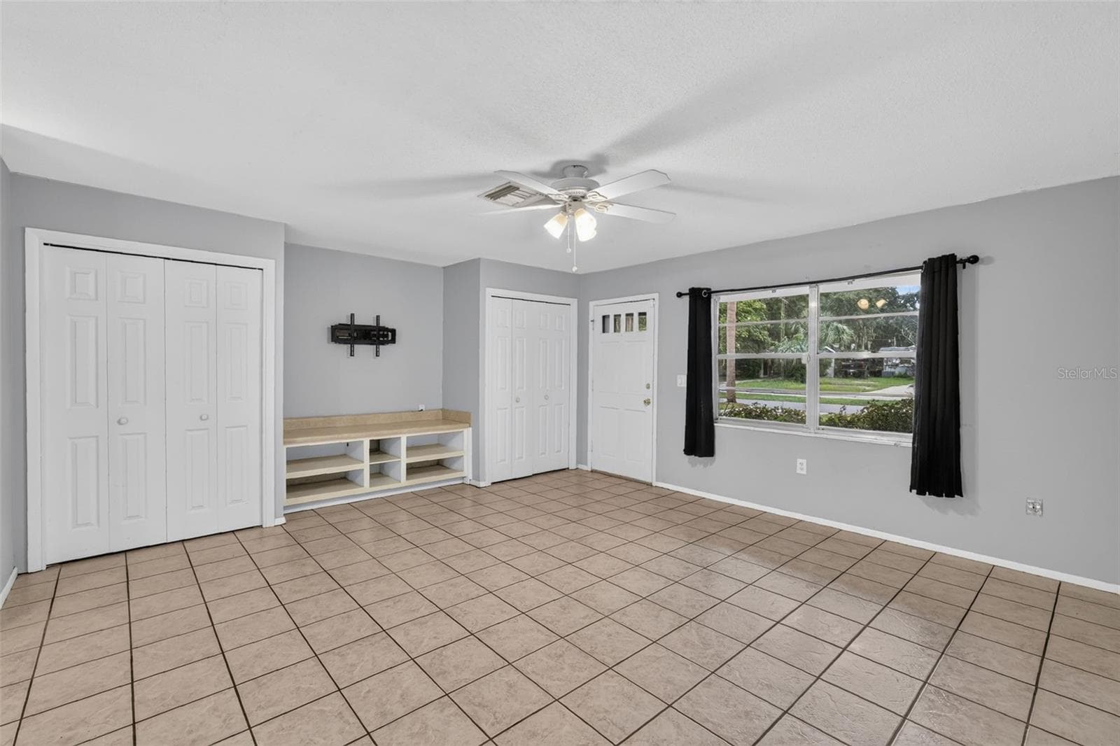 Light Filled Living Area With Neutral Paint and Tile Flooring - 1305 ORANGE AVE, TAVARES