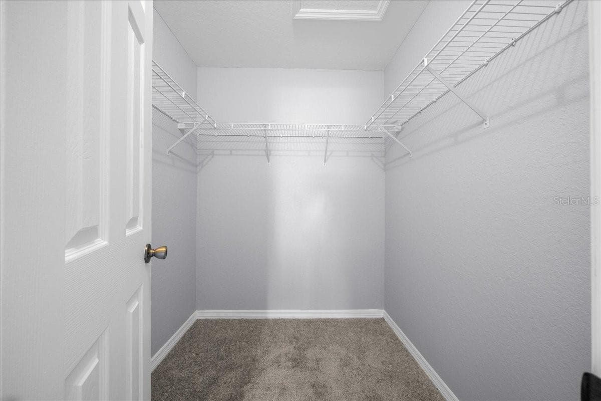 primary walk in closet - 9912 SW 61ST CT, OCALA