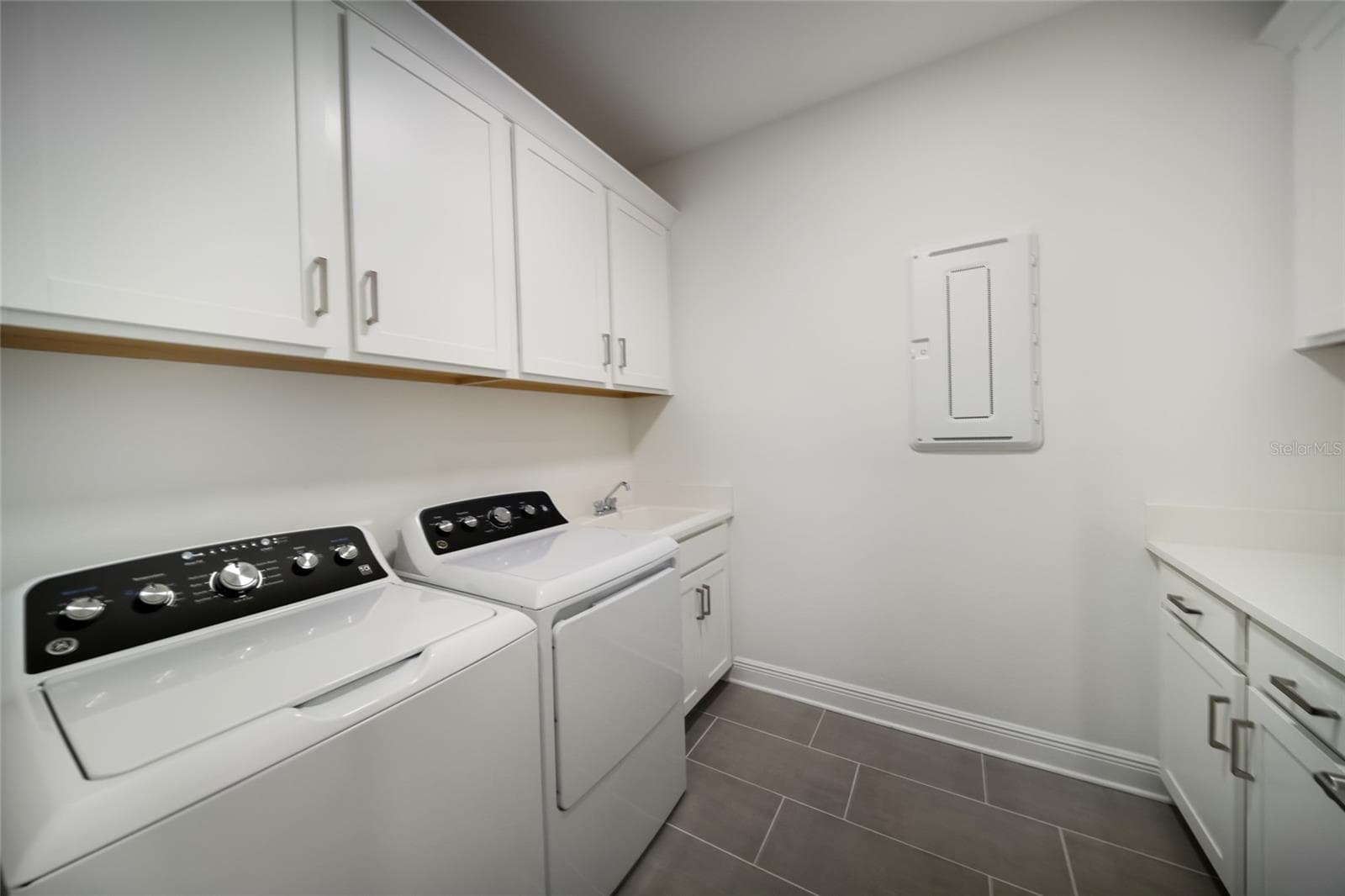 First Floor Laundry Room with Sink and Storage - 4811 HONEY DEW LN, BRADENTON