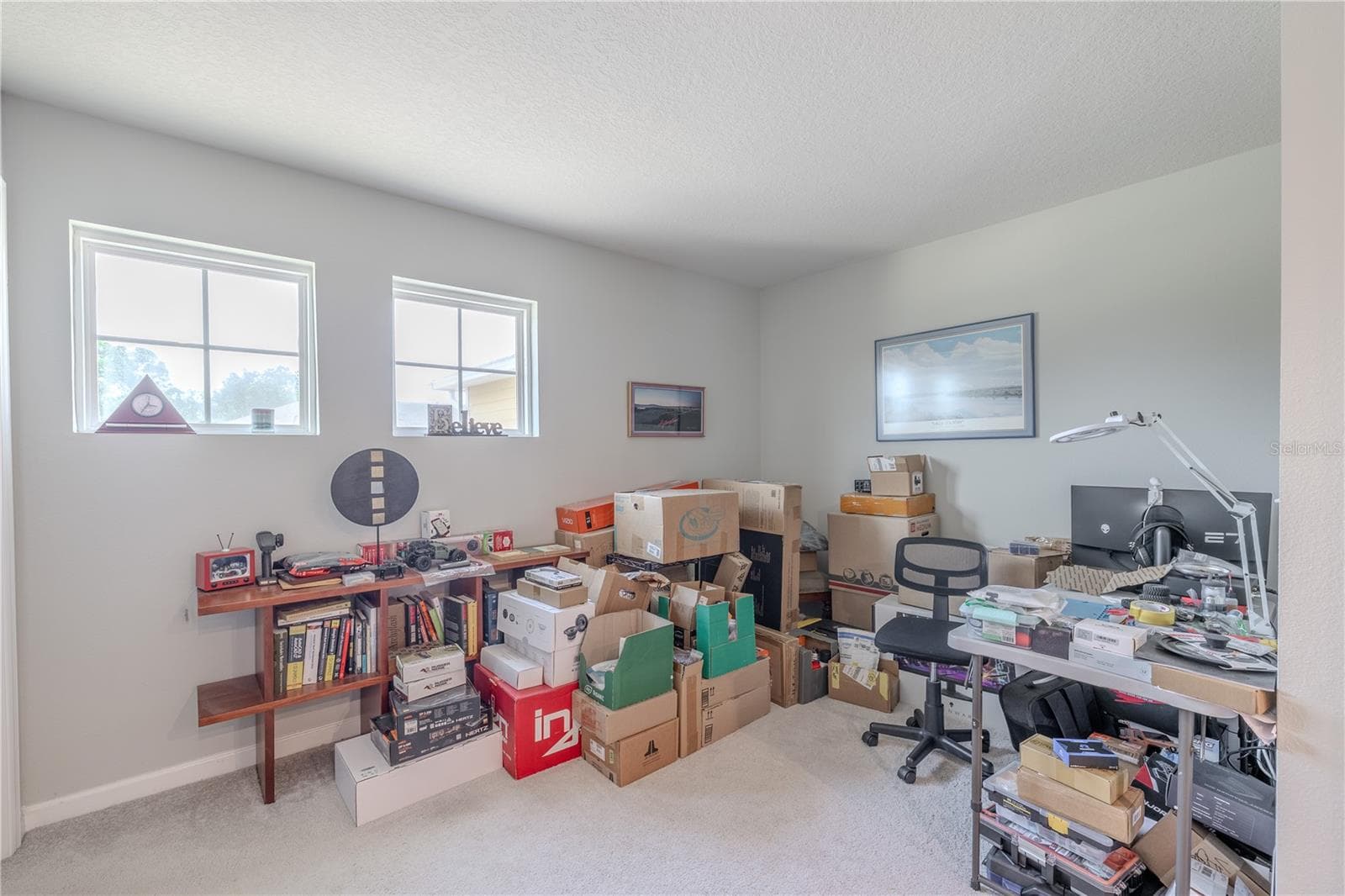 The spacious upstairs loft offers flexible bonus space for a home office, media room, library or hobby area, with two windows, neutral walls and carpet, and plenty of room to make the space your own. - 3029 JACOB CROSSING LN, HOLIDAY
