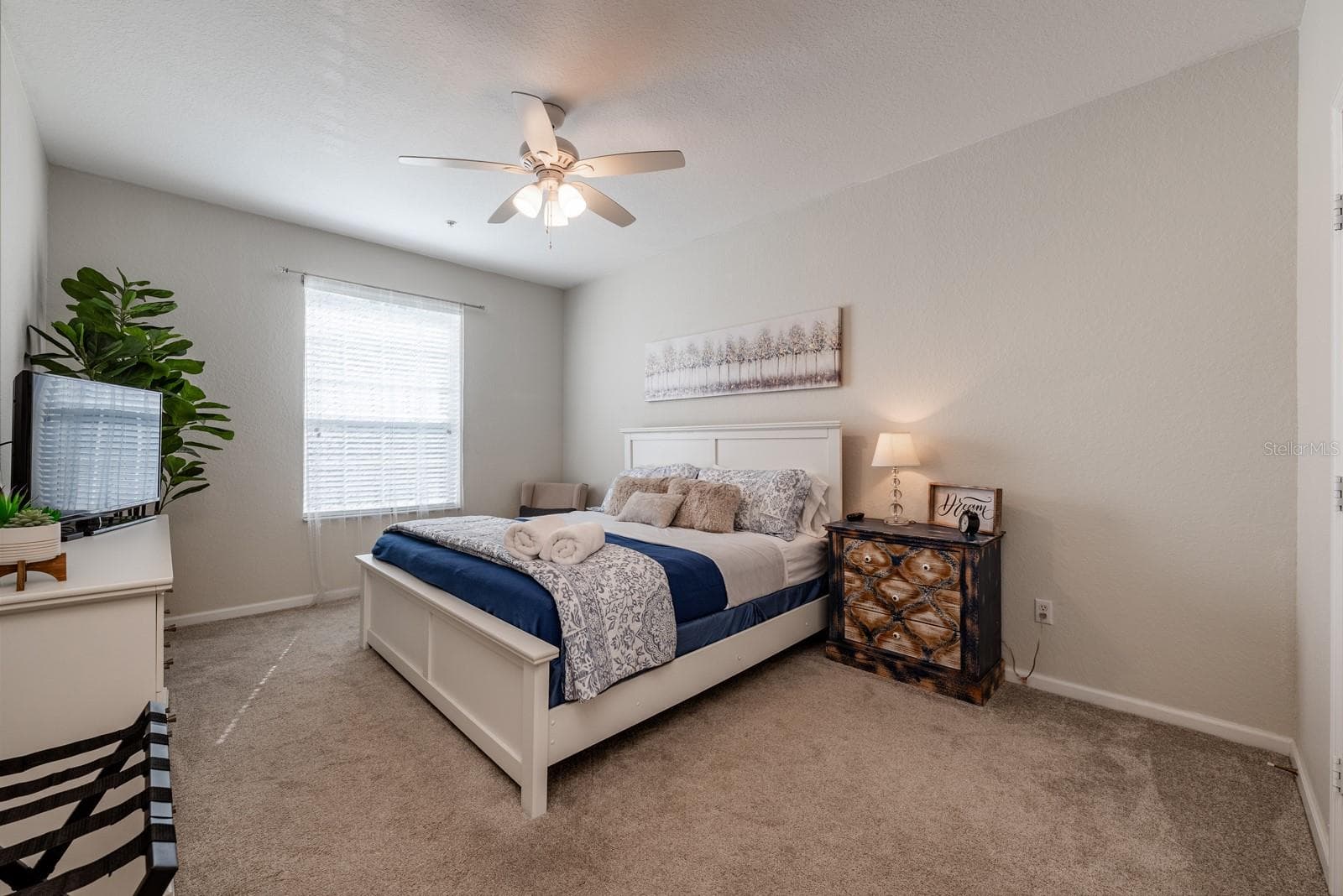 Second Bedroom with ample space includes a King size bed, dresser with TV, and sitting chair. - 2778 ALMATON LOOP #204, KISSIMMEE