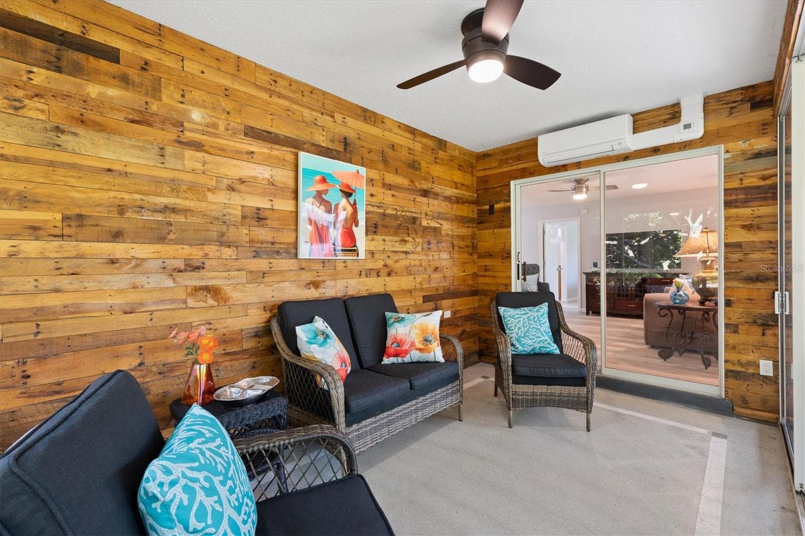 GLASS ENCLOSED LANAI STACKING SLIDING DOORS WITH MINI SPLIT/ AIR CONDITIONING FOR ALL AROUND COMFORT WITH TINTED WINDOWS FOR PRIVACY, SLIDING DOOR LEADS TO A HUGE SCREENED LANAI - 1426 JUAREZ PL, THE VILLAGES