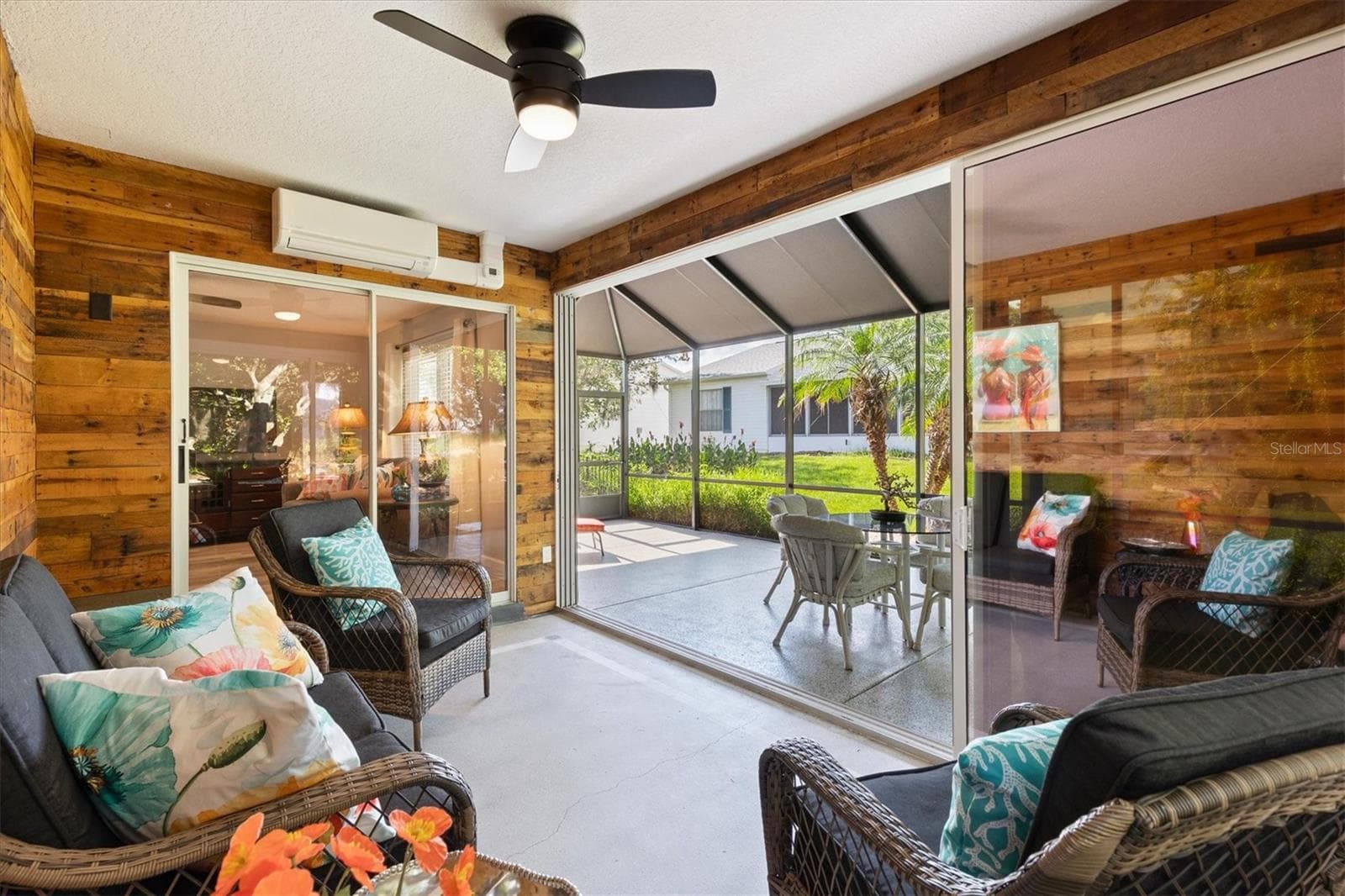 GLASS ENCLOSED LANAI WITH TINTED STACKING SLIDING DOORS LEADING TO HUGE OUTSIDE LANAI OR LIVING ROOM - 1426 JUAREZ PL, THE VILLAGES