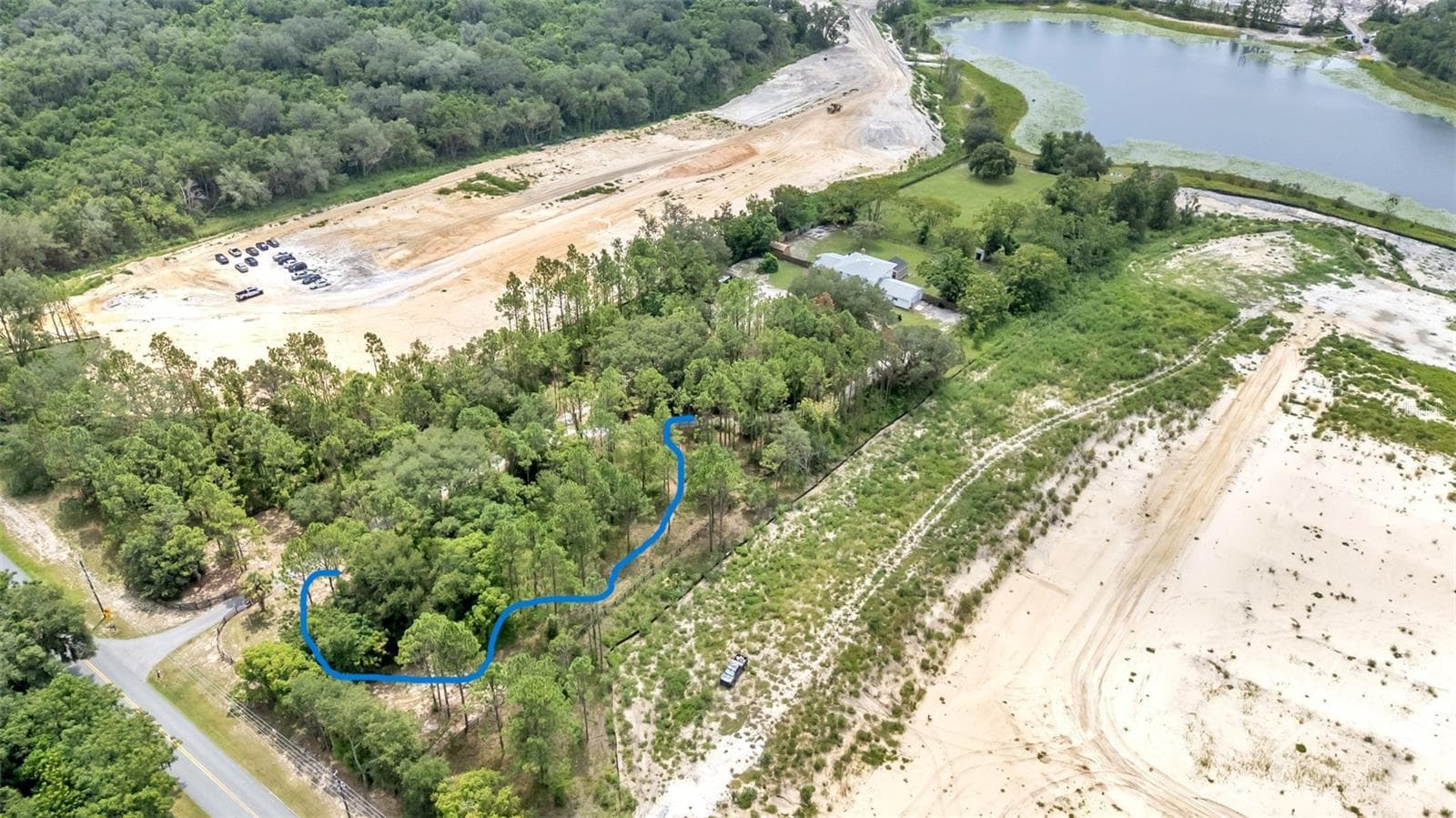 the blue line shows a small dirtbike/quad track - 2406 LAKE ELLA RD, FRUITLAND PARK