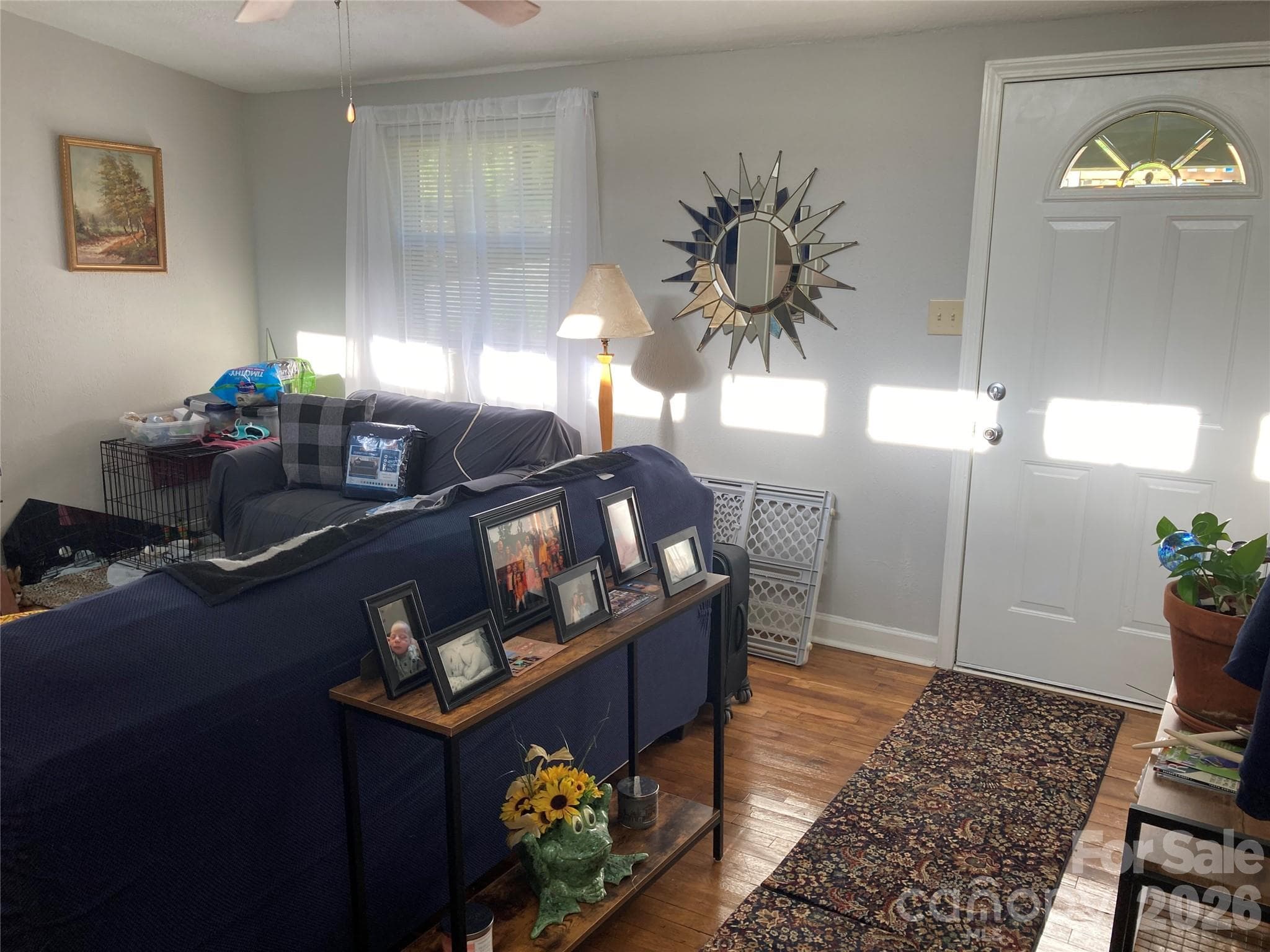 view of sunny living room with previous tenants furniture - 216 Auten Circle, Mount Holly