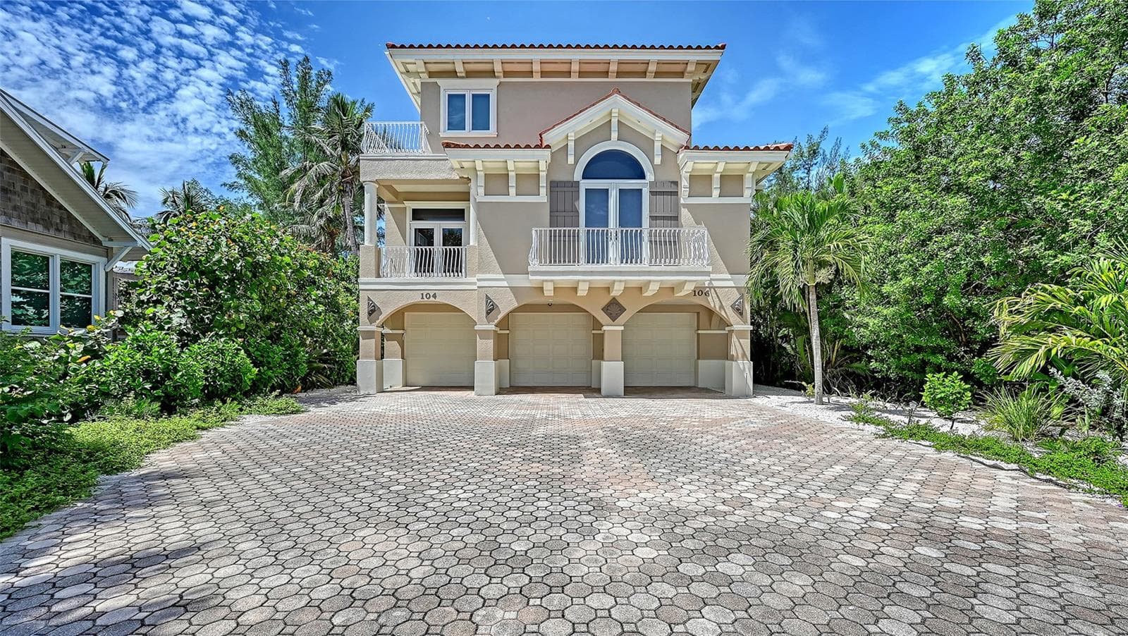 Paver driveway. Tandem parking garage is on the right. It has space for 2 vehicles. - 106 74TH ST #100, HOLMES BEACH