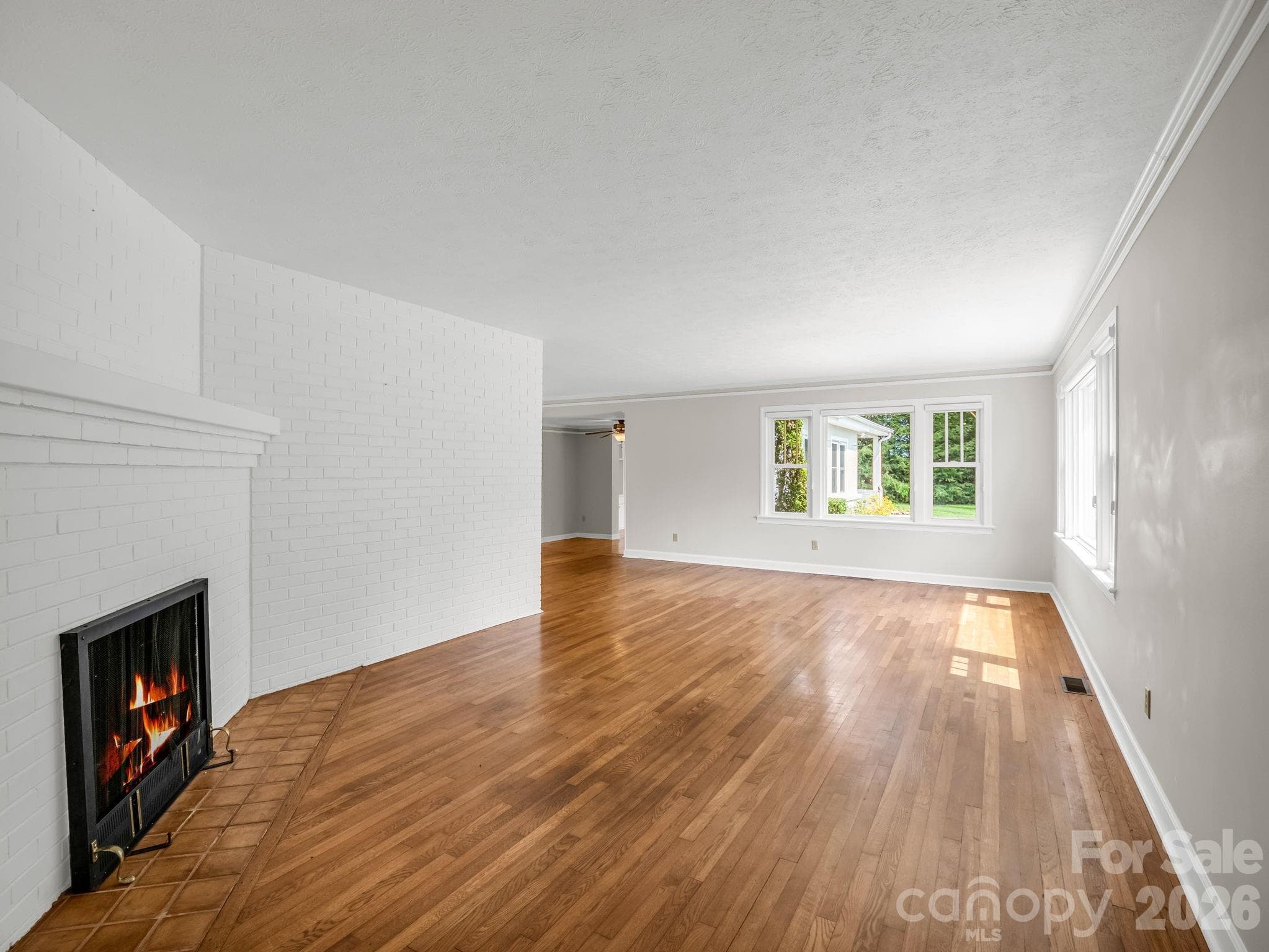 Original hardwood floors and cozy gas fireplace - 370 Orchard Circle, Laurel Park