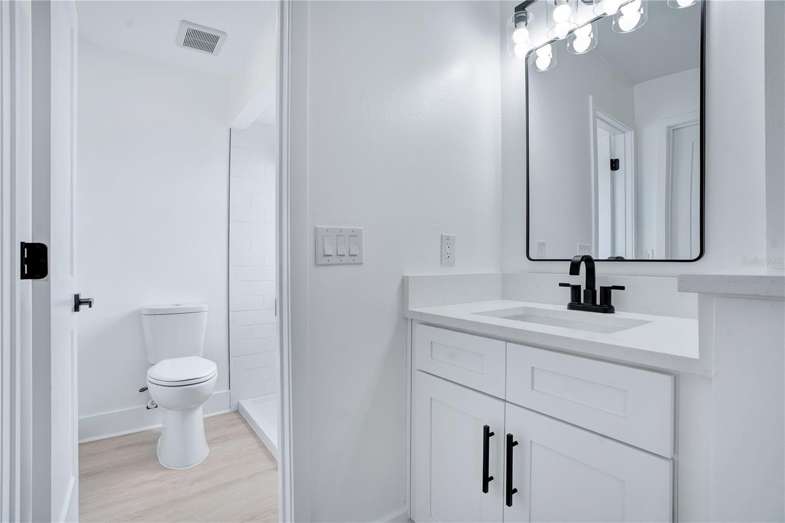 Completely remodeled bathroom featuring new vanity, quartz countertop, modern fixtures and contemporary tilework. - 3012 S SEMORAN BLVD #G2, ORLANDO