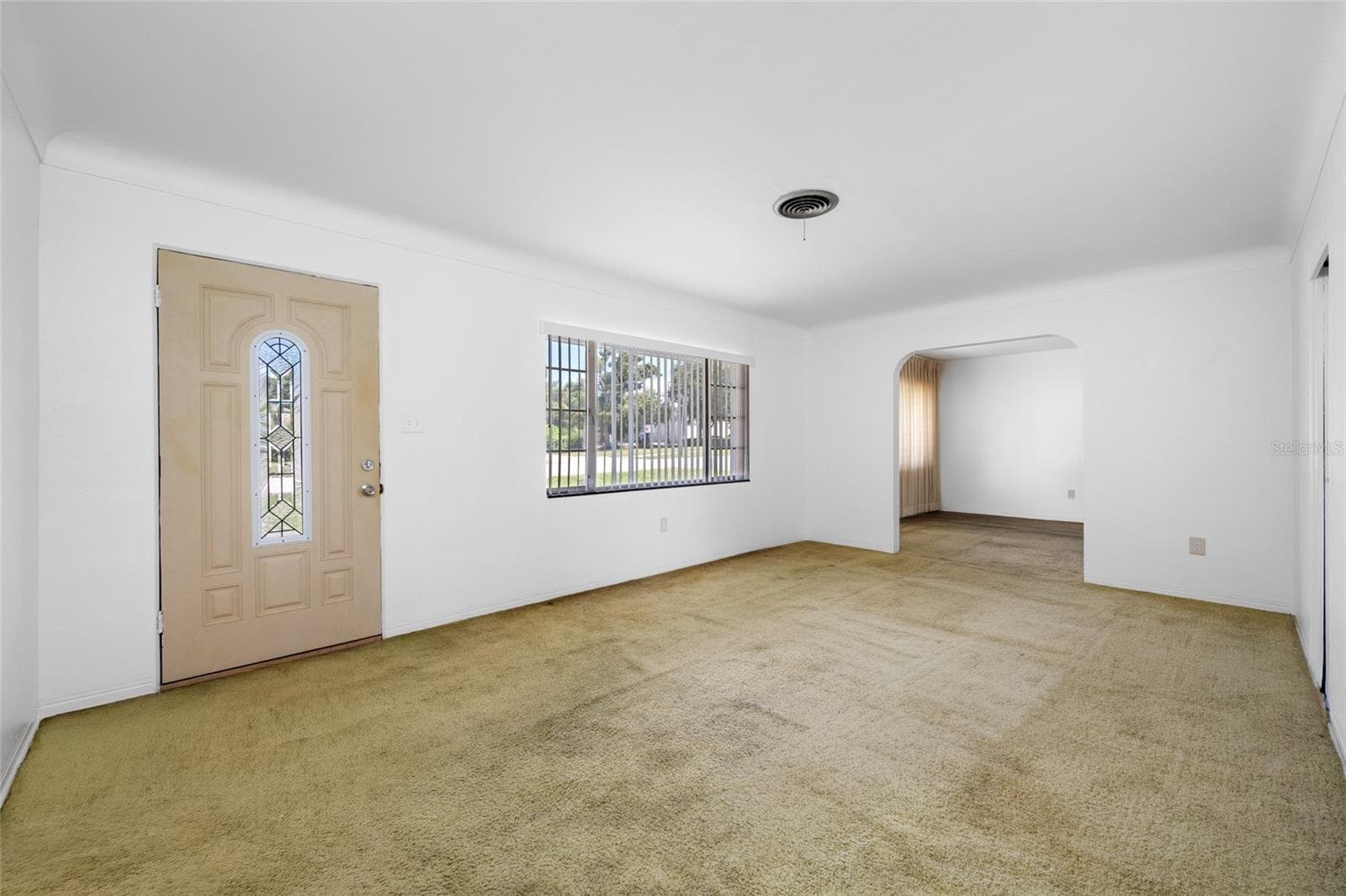 Living room. Original hardwood floors under carpet - 5000 9TH AVE N, ST PETERSBURG