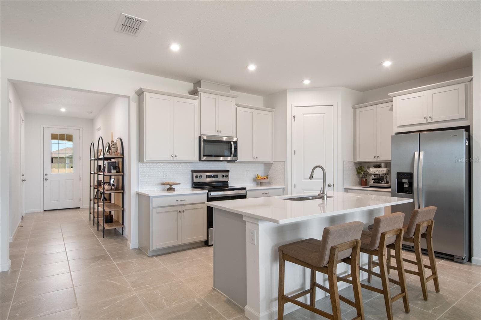 In the far corner is a dedicated walk in pantry. the Microwave and exhaust just above the range, vent to the outside! - 2685 SWEET ACACIA DR, CLERMONT