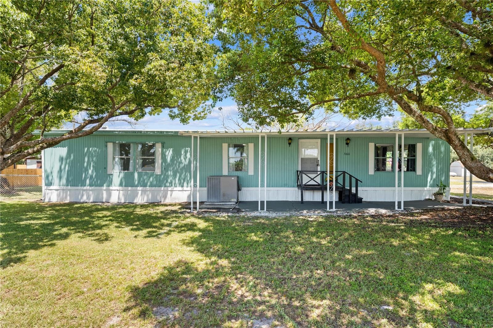 Front exterior with covered porch - 5601 LAKE LIZZIE DR, ST CLOUD
