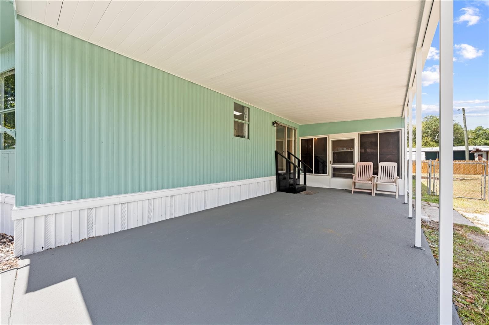 Easily access your kitchen and family room thru the sliding doors after parking - 5601 LAKE LIZZIE DR, ST CLOUD