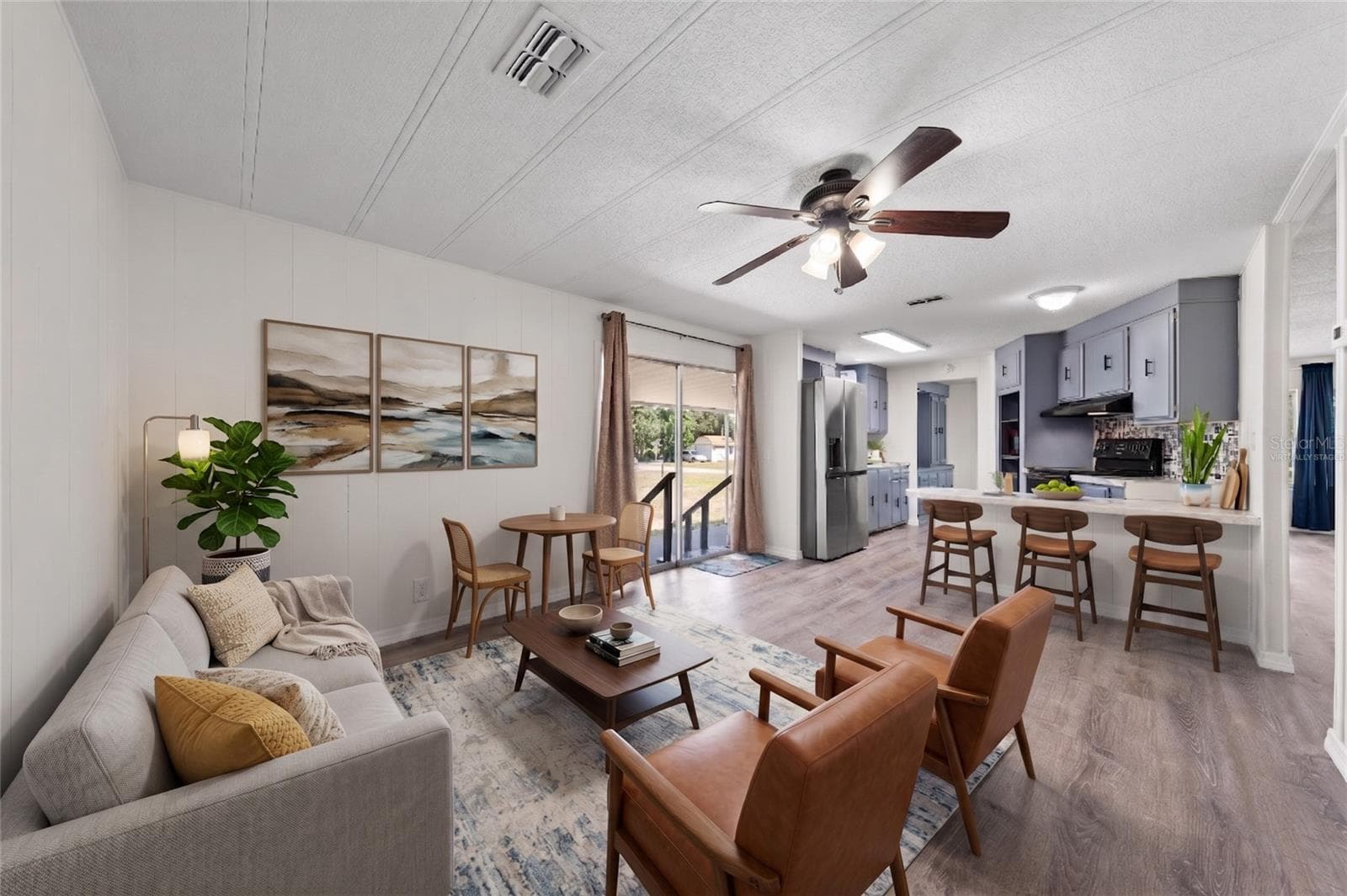 Virtually staged. Cute and cozy idea of what you can do with this space, conveniently open to the kitchen. - 5601 LAKE LIZZIE DR, ST CLOUD