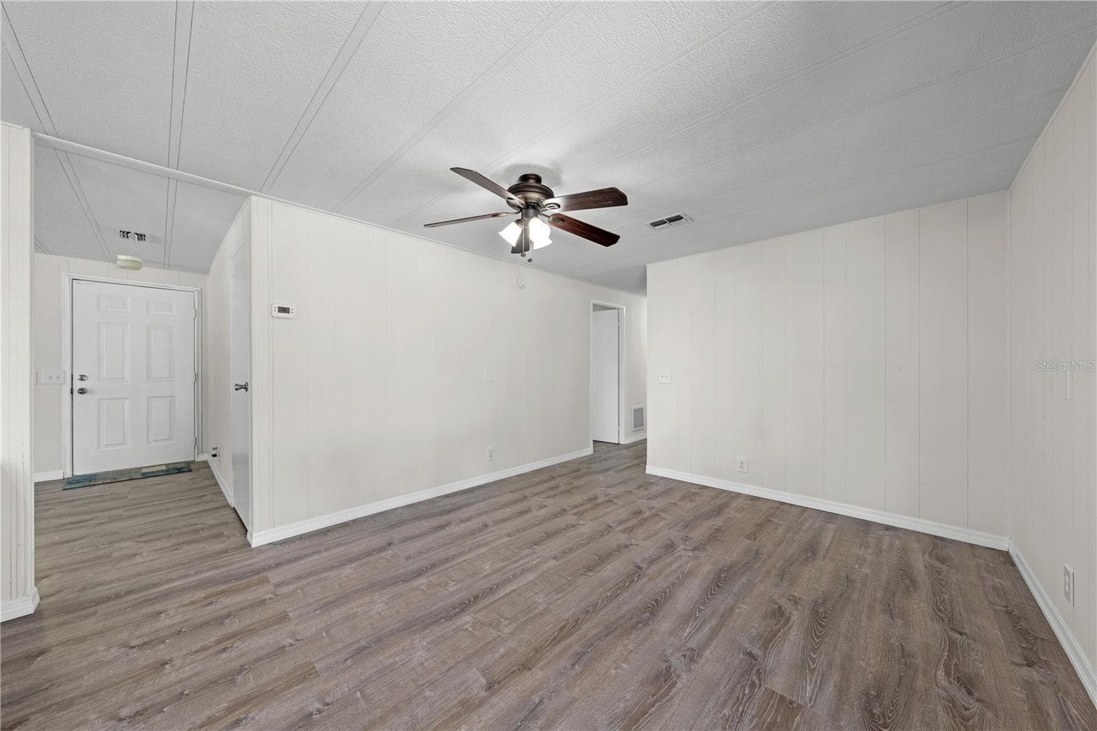 Another view of flex family room, front entry, entry coat closet. and hallway. - 5601 LAKE LIZZIE DR, ST CLOUD