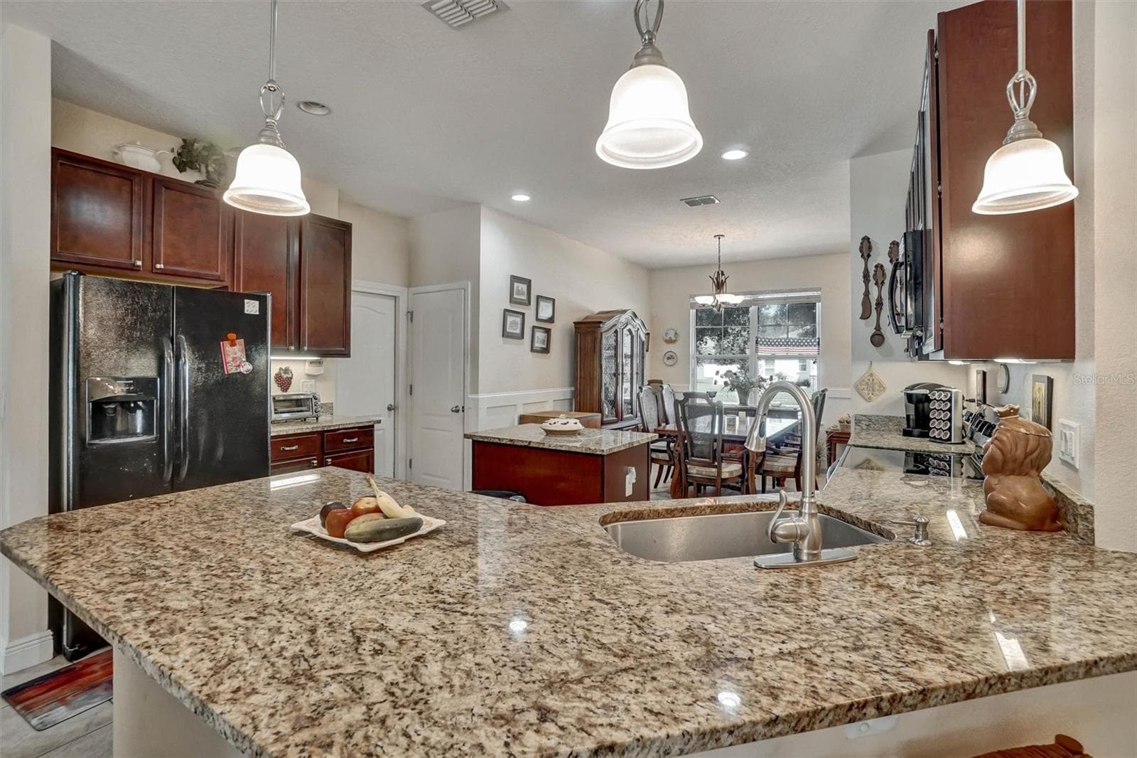 Kitchen CountertopLarge granite countertop provides generous workspace and overlooks the dining area. - 1720 LADY FERN TRL, DELAND