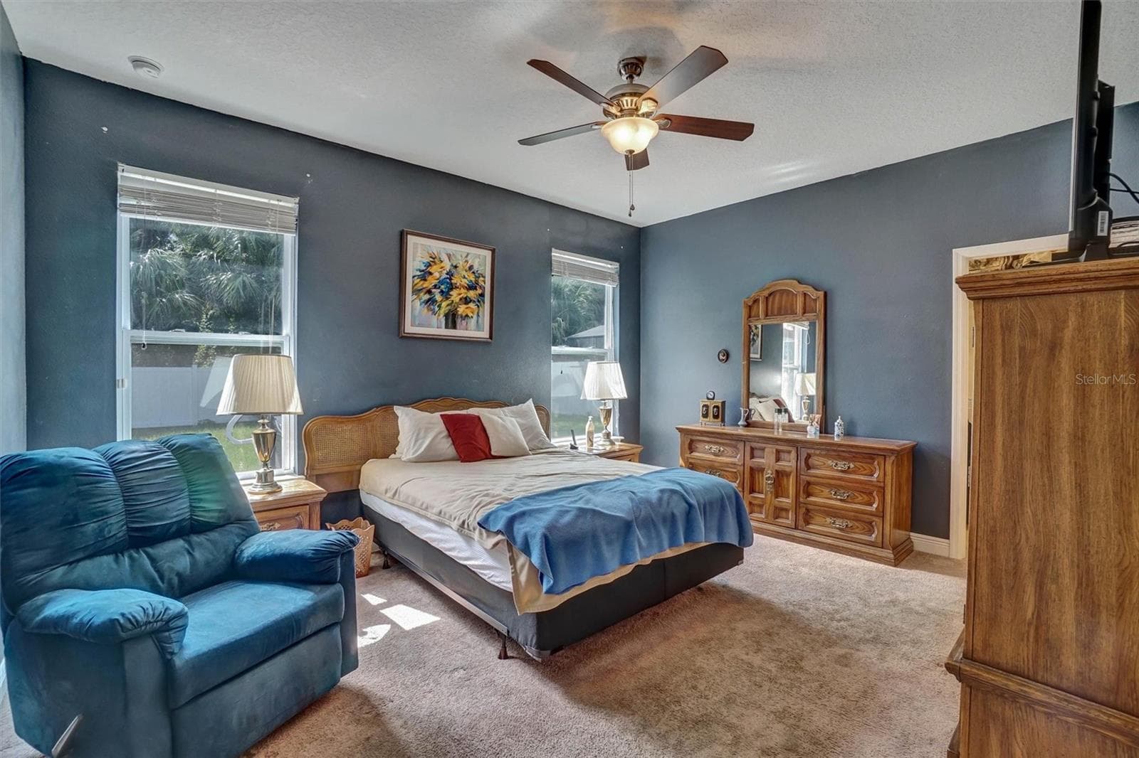 Primary BedroomSpacious primary bedroom with ceiling fan, and abundant natural light. - 1720 LADY FERN TRL, DELAND