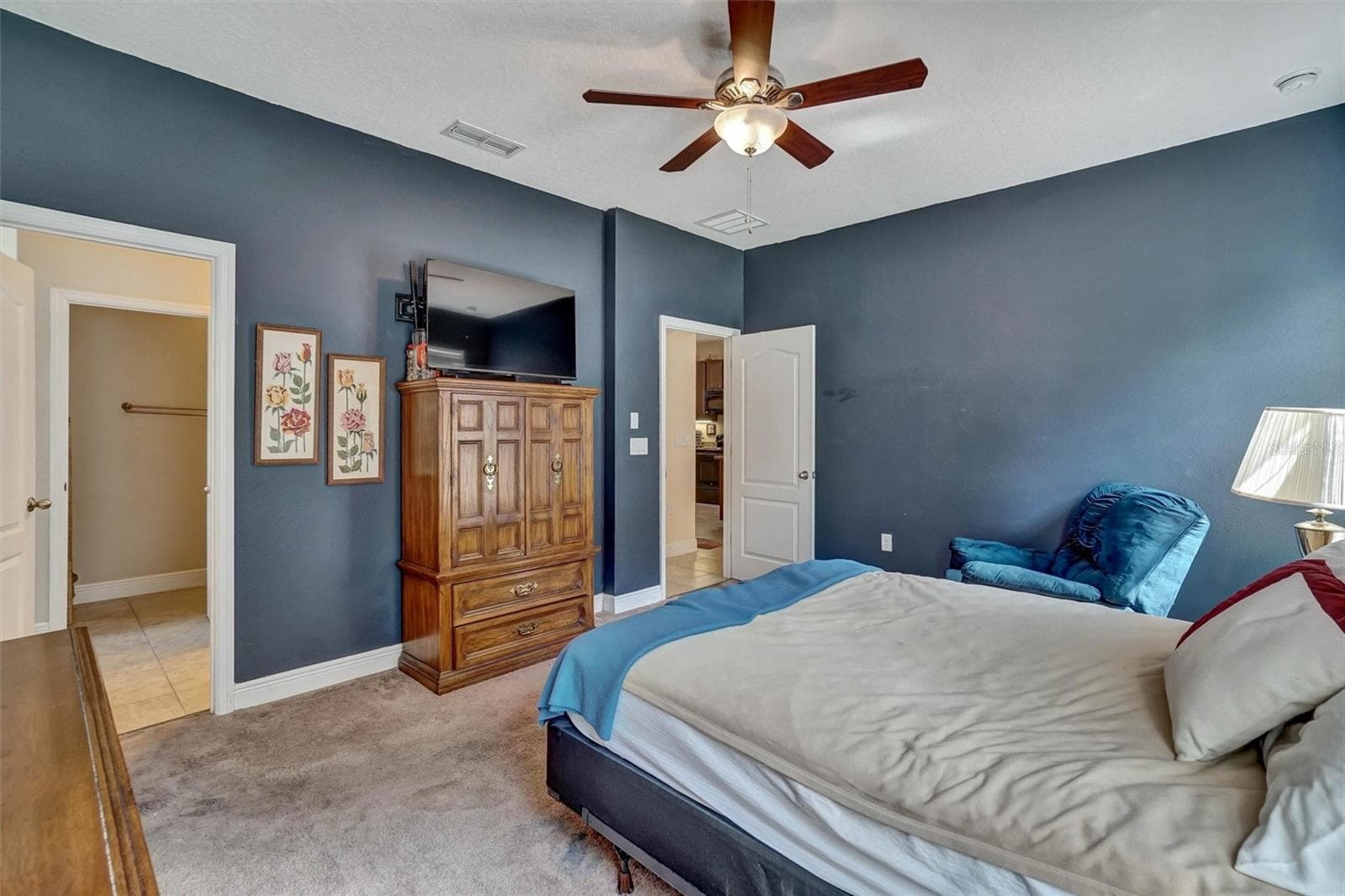Bedroom ViewComfortable primary bedroom featuring a ceiling fan and ample storage. - 1720 LADY FERN TRL, DELAND