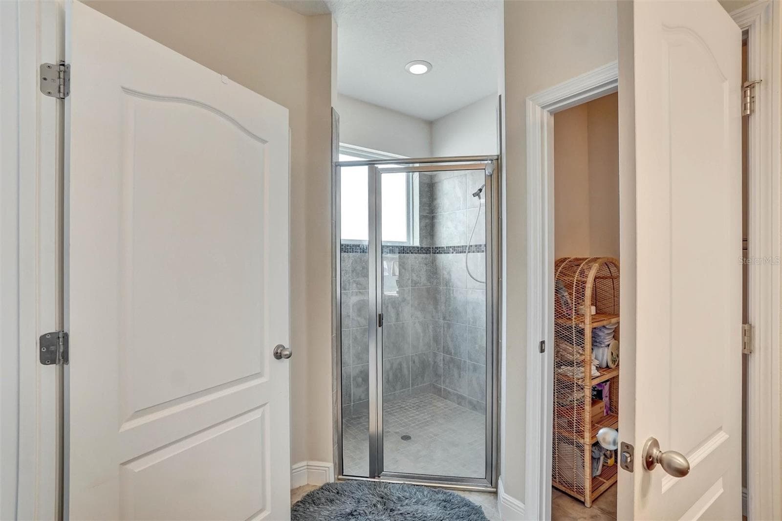 Walk-In ShowerSpacious shower with tiled walls, glass doors, and built-in lighting. - 1720 LADY FERN TRL, DELAND