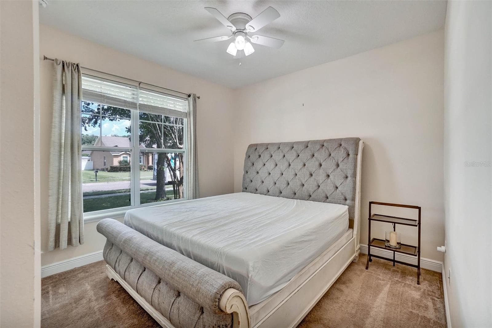 Second BedroomBright bedroom with a ceiling fan, carpeted flooring, and a large window - 1720 LADY FERN TRL, DELAND