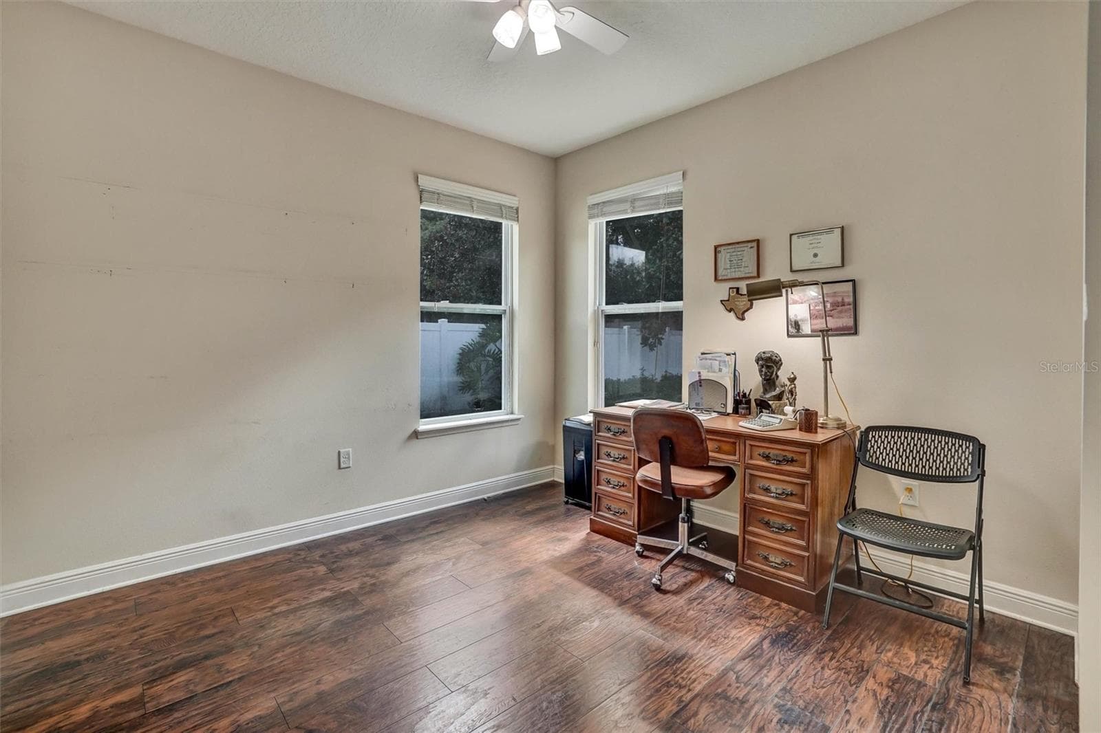 Third BedroomSpacious third bedroom with wood-look flooring, ceiling fan. - 1720 LADY FERN TRL, DELAND