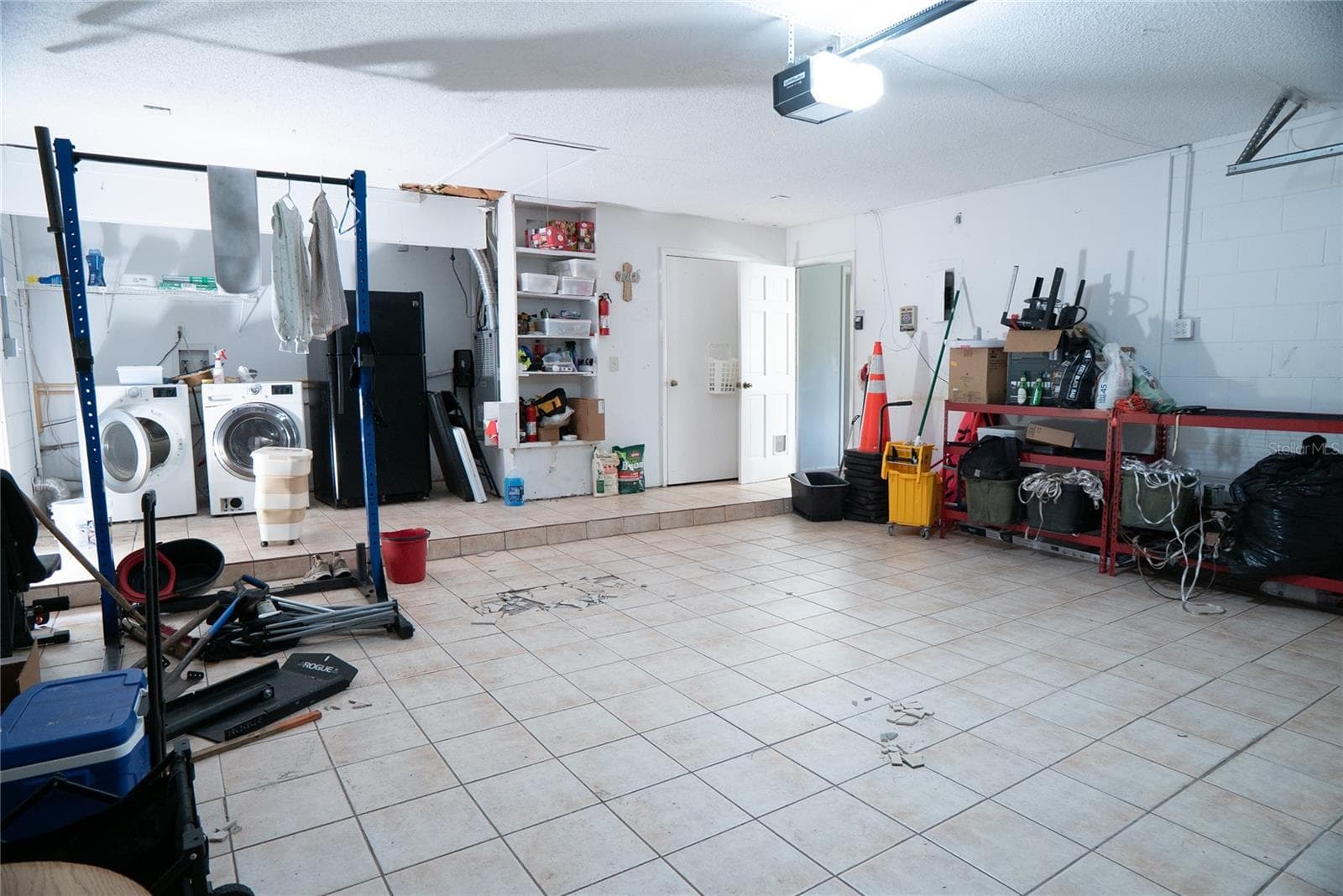 Tiled Two Car Garage with Laundry inside garage - 304 SHADOW OAK DR, CASSELBERRY