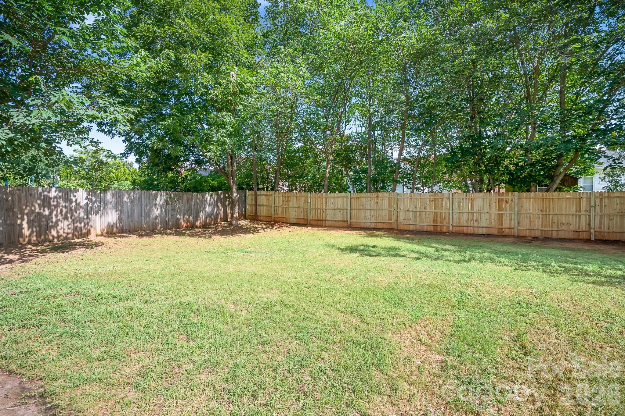 Spacious, fully fenced backyard offering privacy and plenty of possibilities - 104 1st Avenue, China Grove