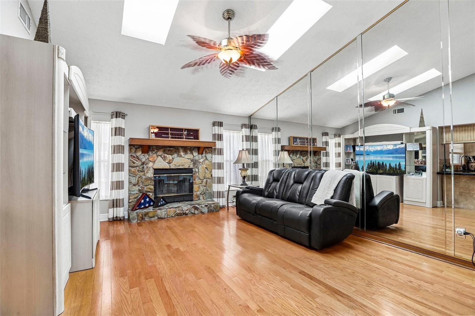Family room with sky lights and wood burning fireplace - 1424 DUMONT DR, VALRICO