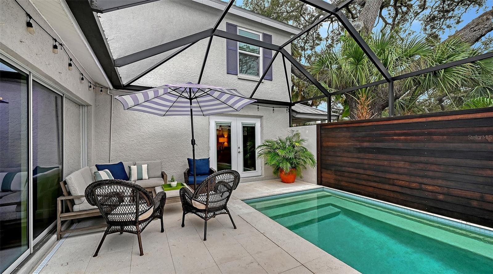 Heated pool and screened courtyard lanai offer a sophisticated private oasis designed for effortless Florida outdoor living. - 1685 6TH ST, SARASOTA