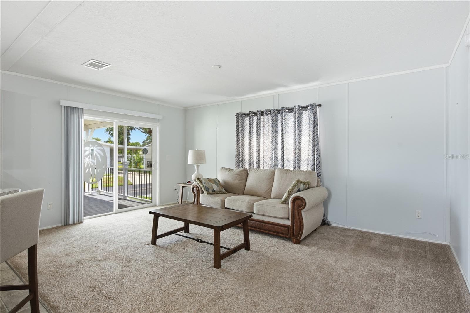 Living room with sliding doors to spacious, covered front porch - 980 7TH ST NW #88, LARGO
