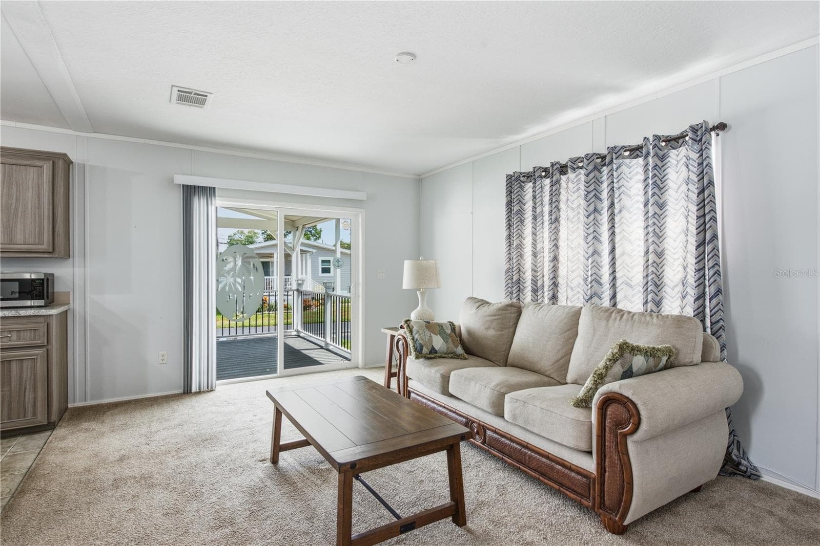 Living room with sliders to the spacious covered front porch - 980 7TH ST NW #88, LARGO