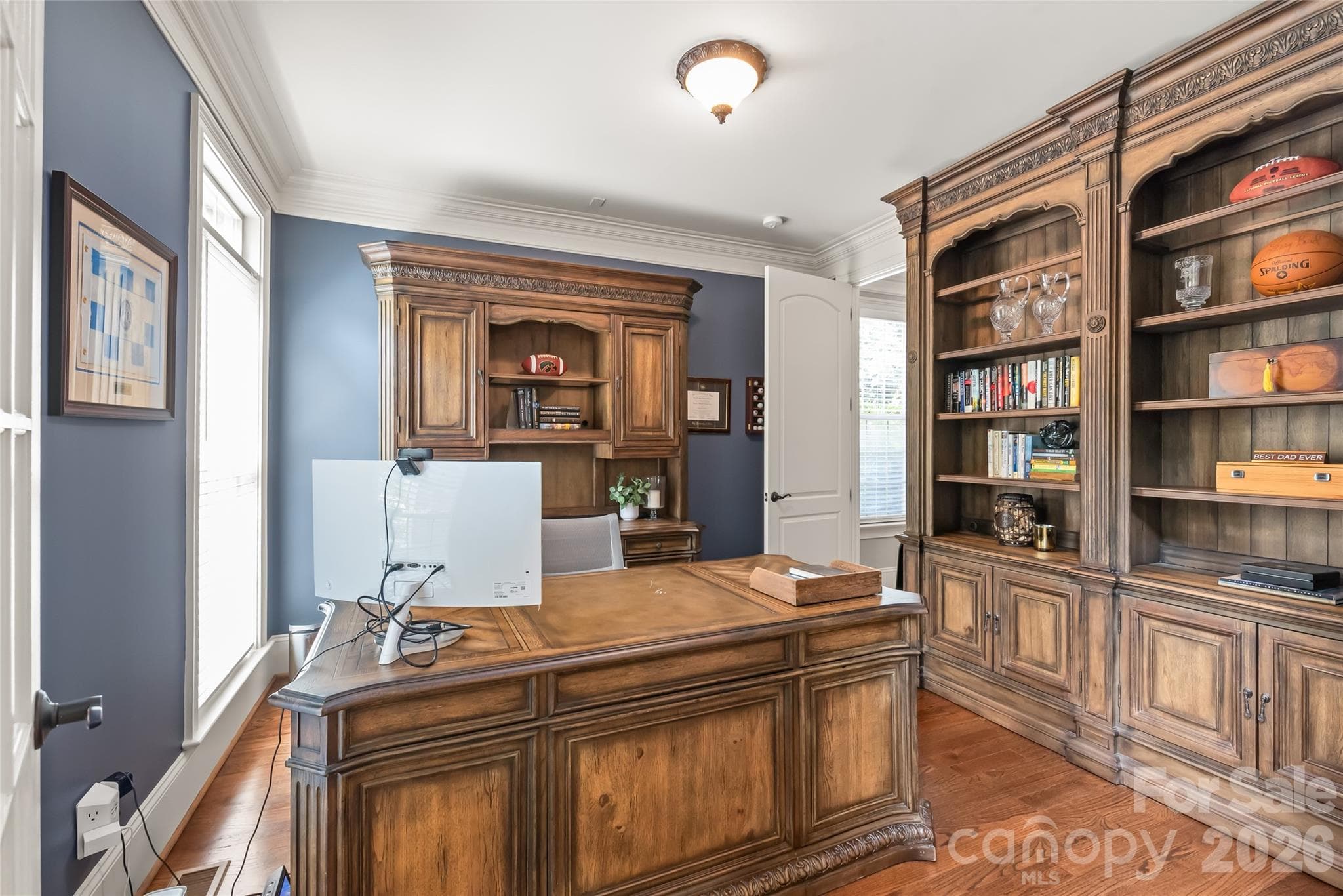 The executive office connects seamlessly to a main-floor guest suite or playroom, complete with its own full bathroom. - 7320 Summerlin Place, Charlotte
