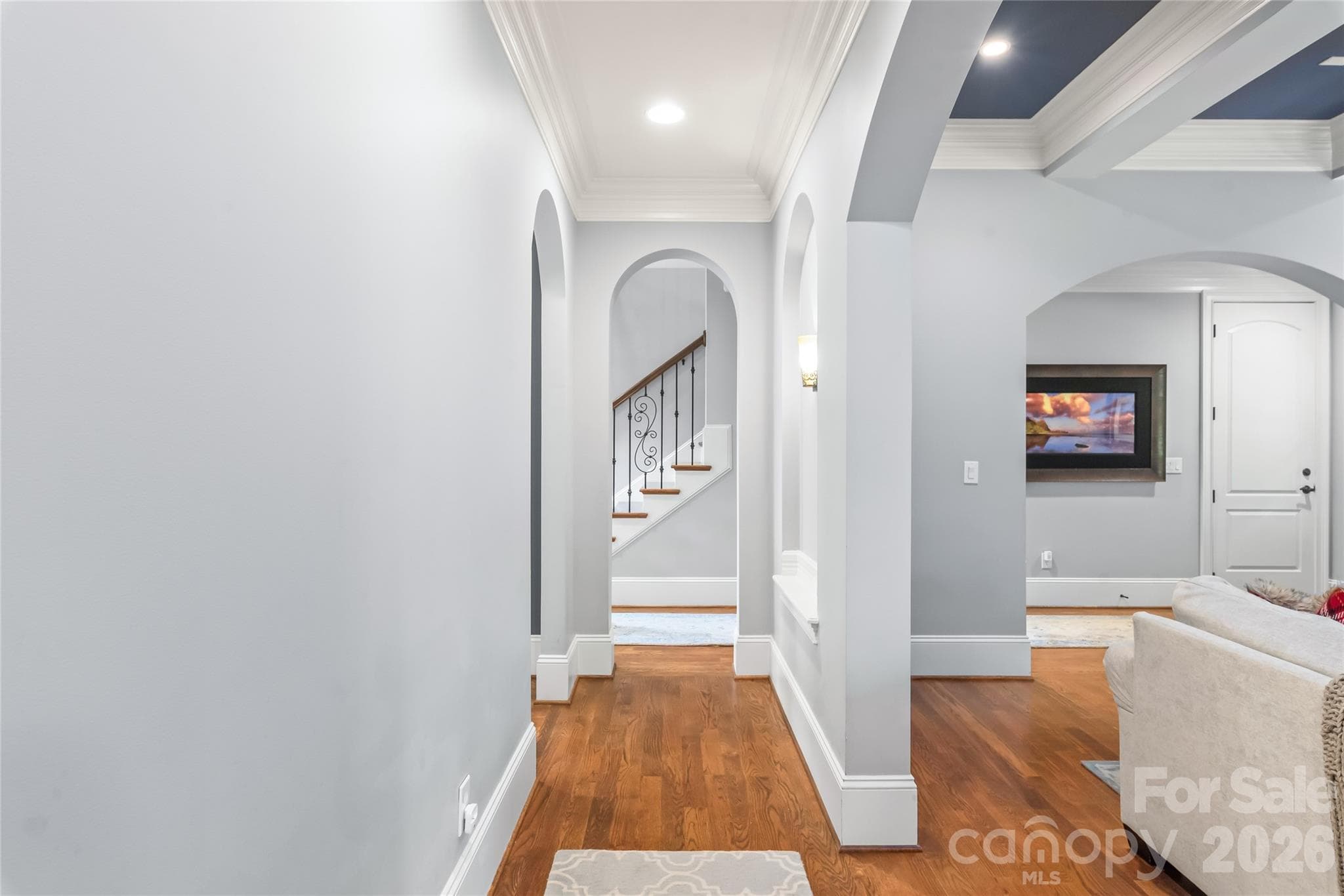 Architectural arches, substantial heavy crown molding, and high-profile baseboards come together to give the space a classic, custom finish. - 7320 Summerlin Place, Charlotte