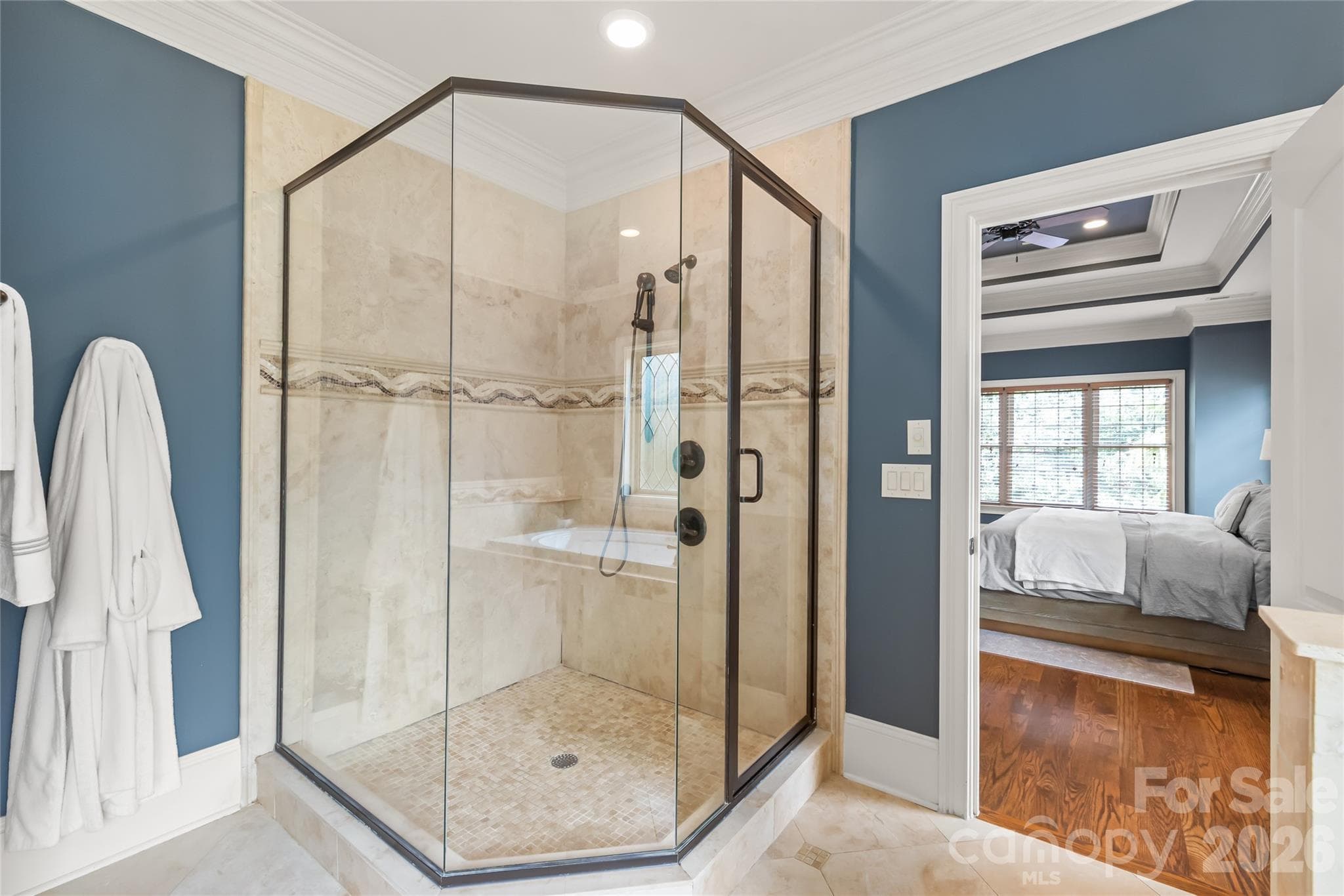 A clean-lined walk-in shower features semi-frameless glass for a sleek, open feel. - 7320 Summerlin Place, Charlotte