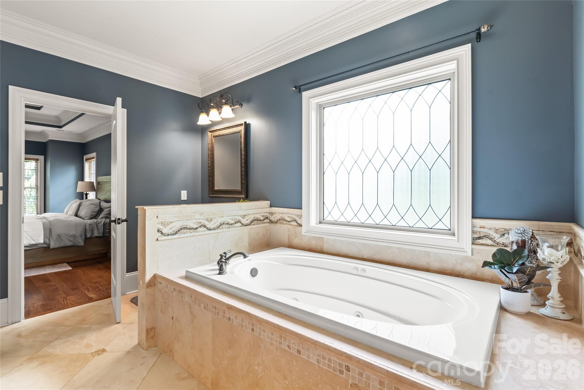 A deep soaking tub serves as the centerpiece of the en-suite, perfect for unwinding in total comfort. - 7320 Summerlin Place, Charlotte