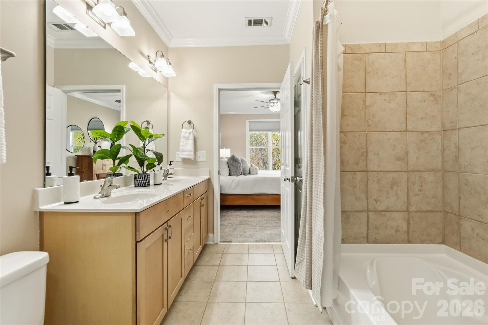 View from the walk-in closet to the primary bathroom - 1000 E Woodlawn Road, Charlotte