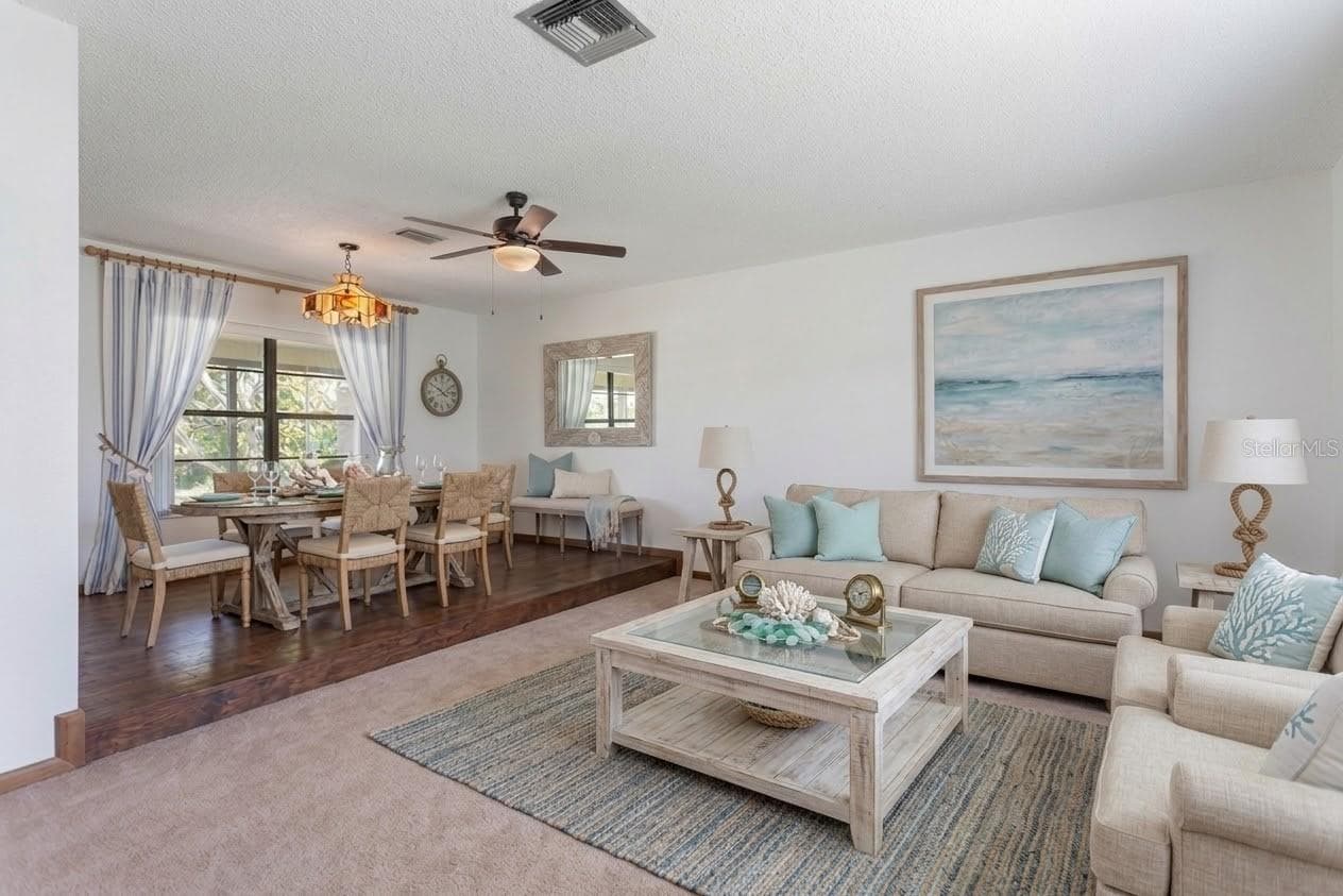 Staged photo of the formal living room and dining room - 9009 HEATHER BLVD, WEEKI WACHEE