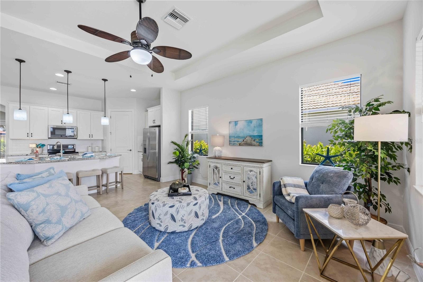 The living /great room in this home shares space with the dining area - - 23781 WAVERLY CIR, VENICE