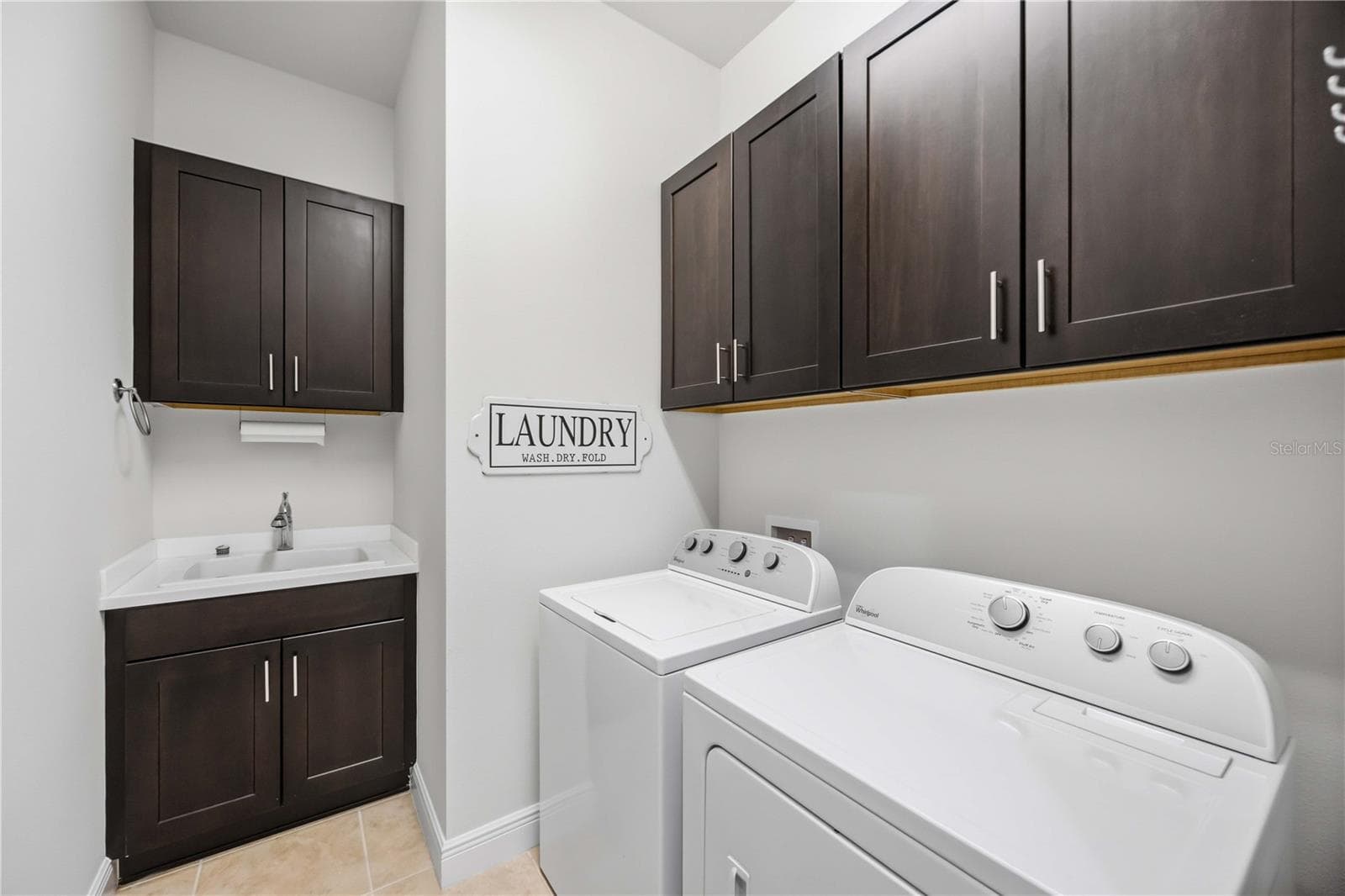The laundry area has a utility sink and washer /dryer. - 23781 WAVERLY CIR, VENICE