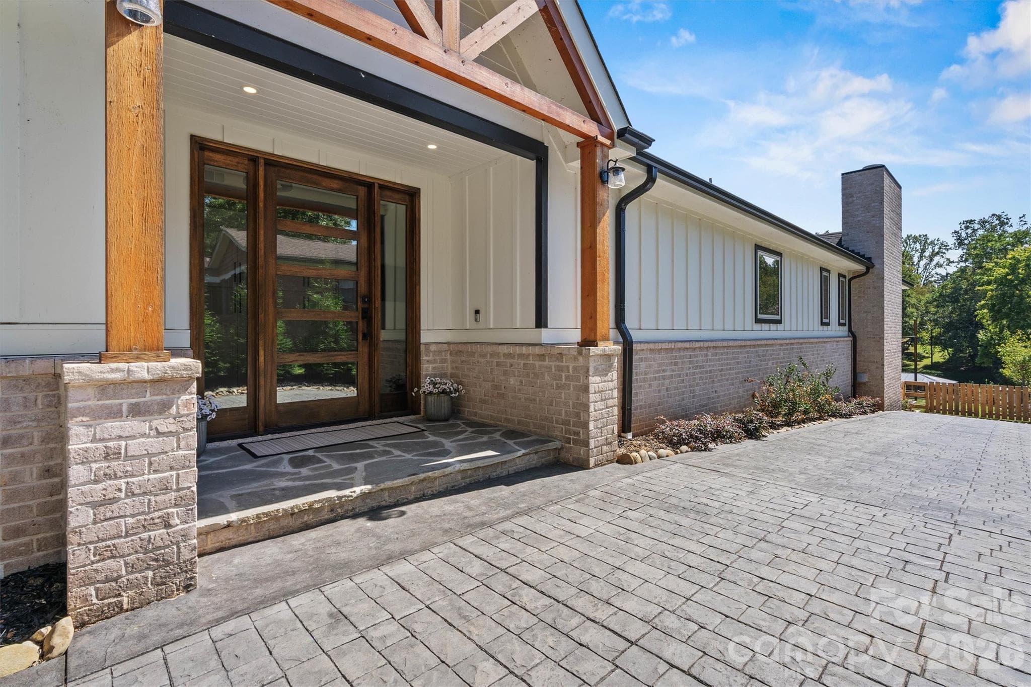Stamped drive to oversized solid-wood front door and to rear yard. - 7834 Green Cove Court, Denver