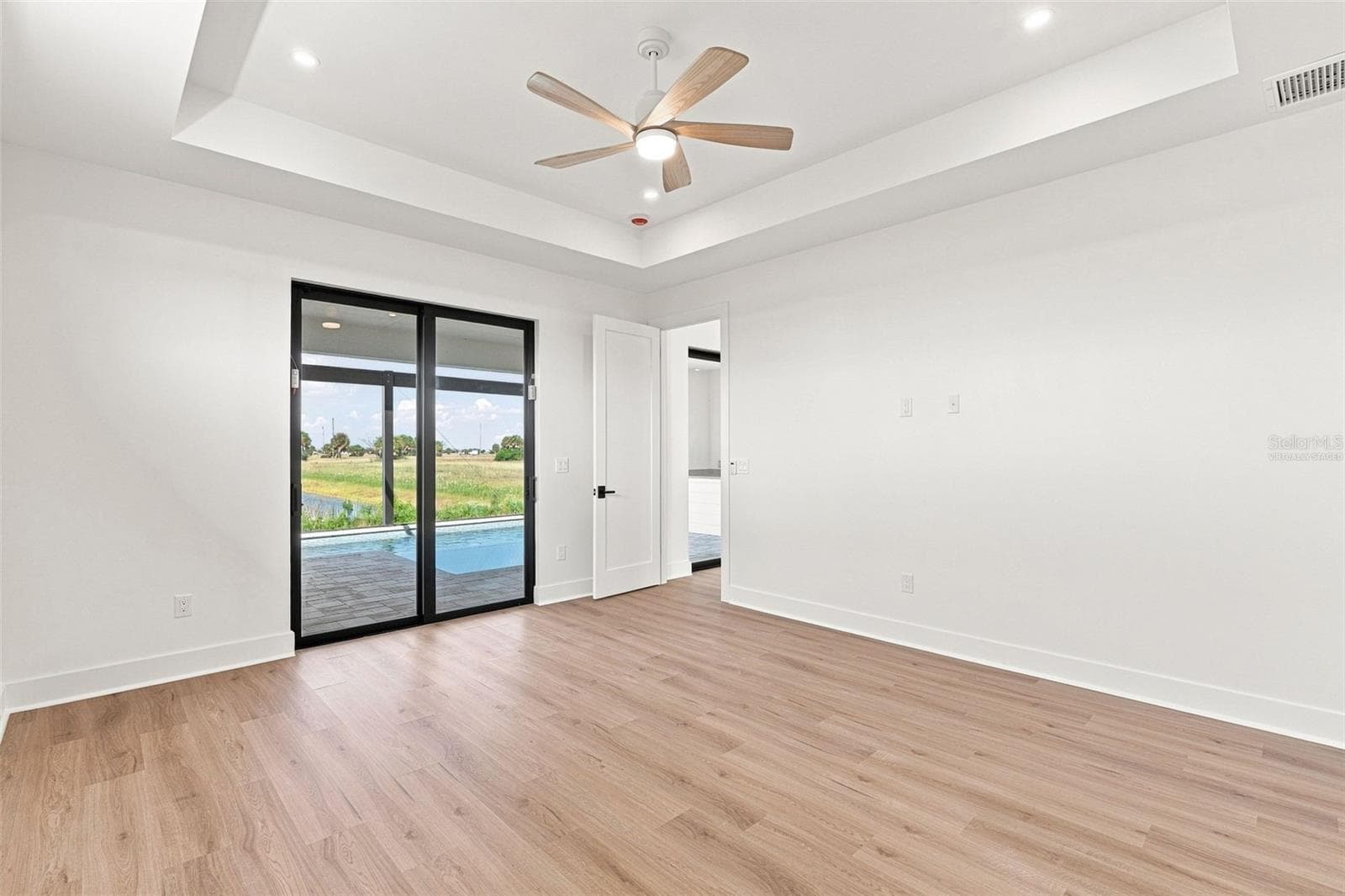 Virtually Staged Primary Suite with Tray Ceiling & Patio Access - 44 SUNFLOWER DR, PLACIDA