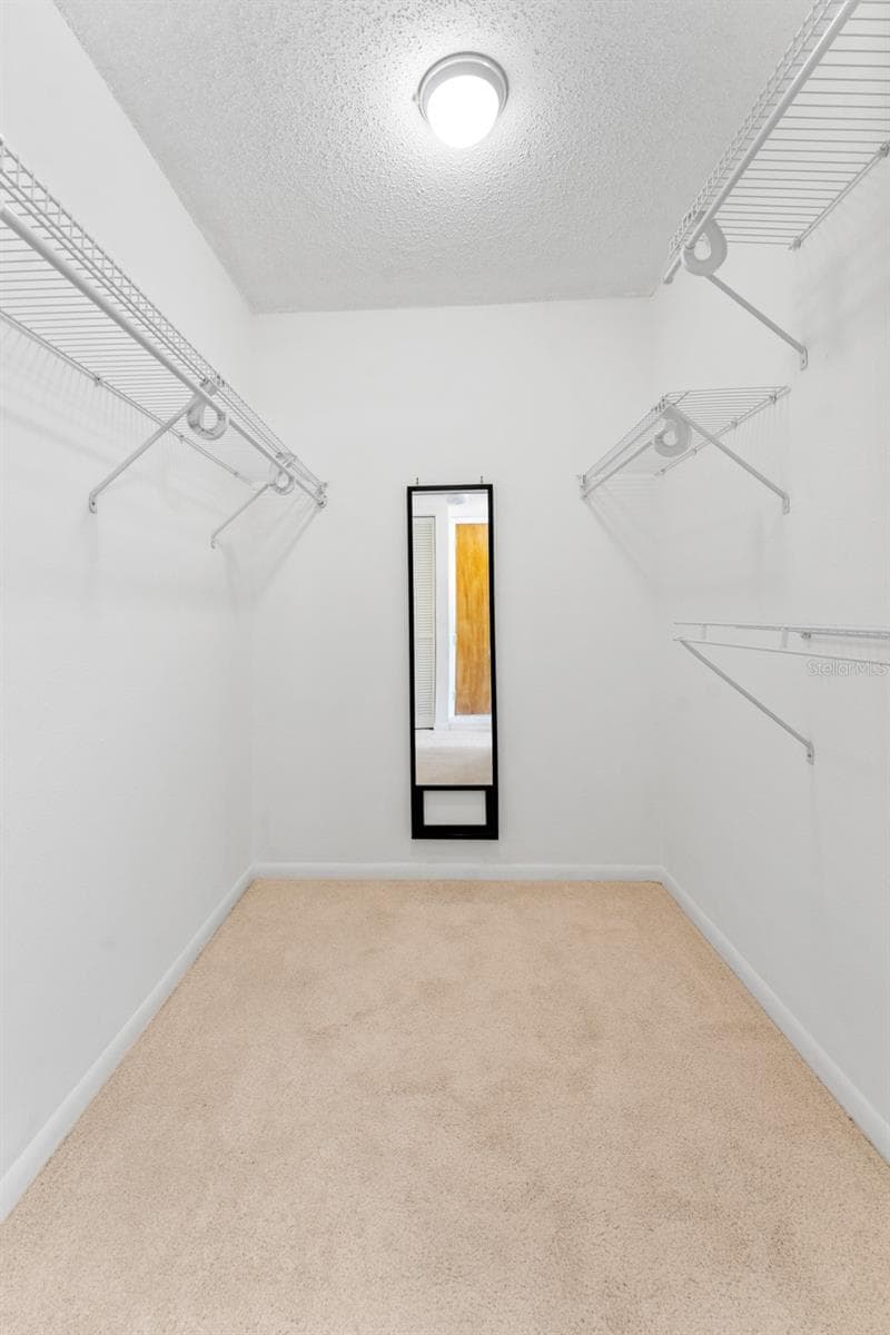 Large walk in closet in Primary bedroom, this is one of 3 closets in the Primary. - 5400 PARK ST N #511, ST PETERSBURG