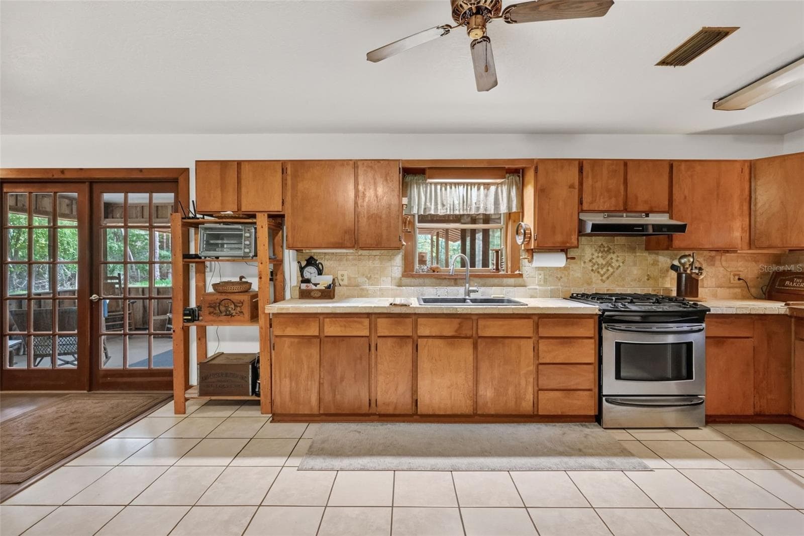 Full on view of kitchen, window out to covered porch - 24939 OLD DEER RD, PAISLEY