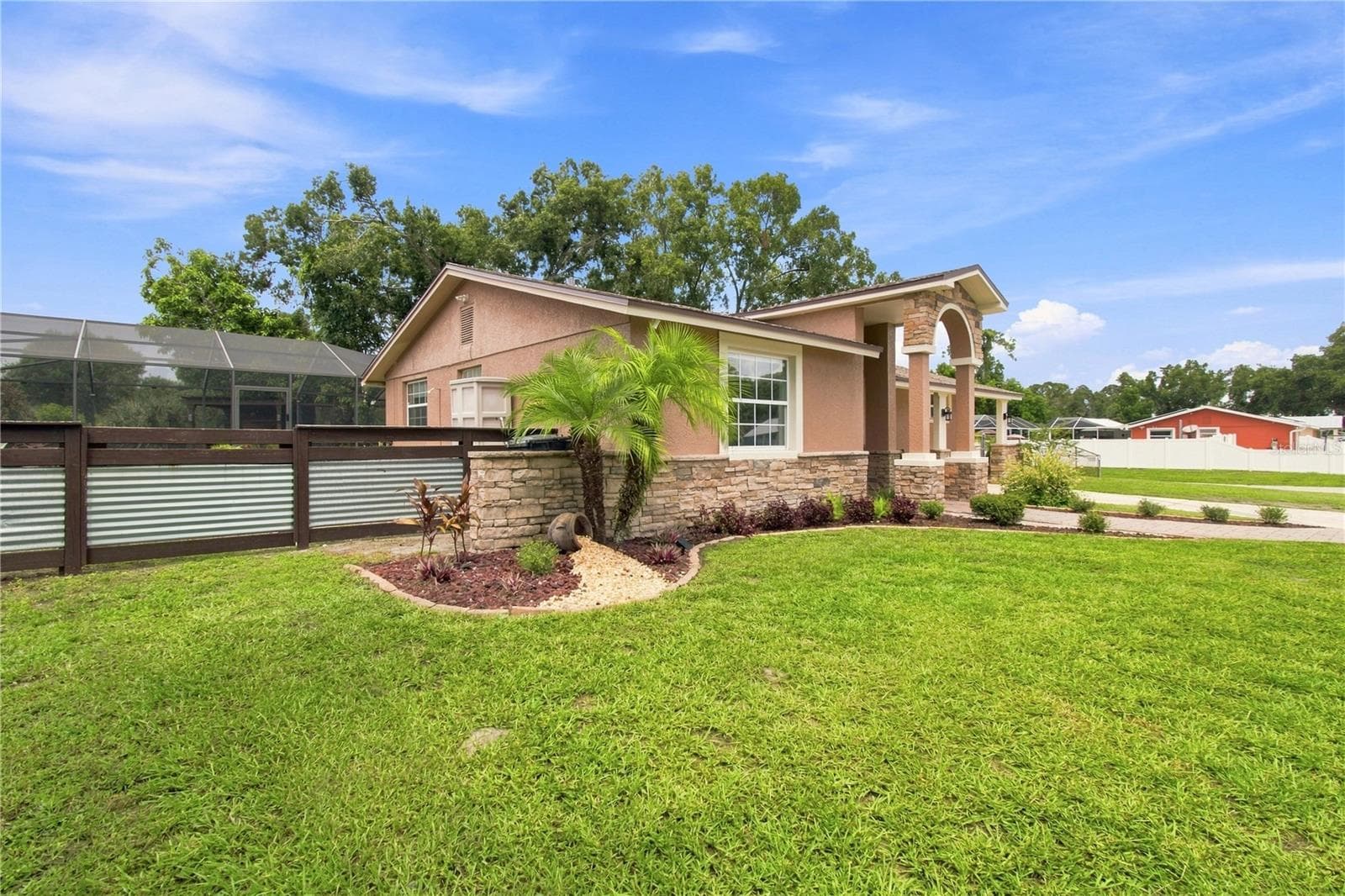 Front View warm color stone decor blends for a cohesive upgrade look, with Portico and Porch, paved walkway to complete the beautiful curb appeal. - 9020 AUBURN WAY, TAMPA