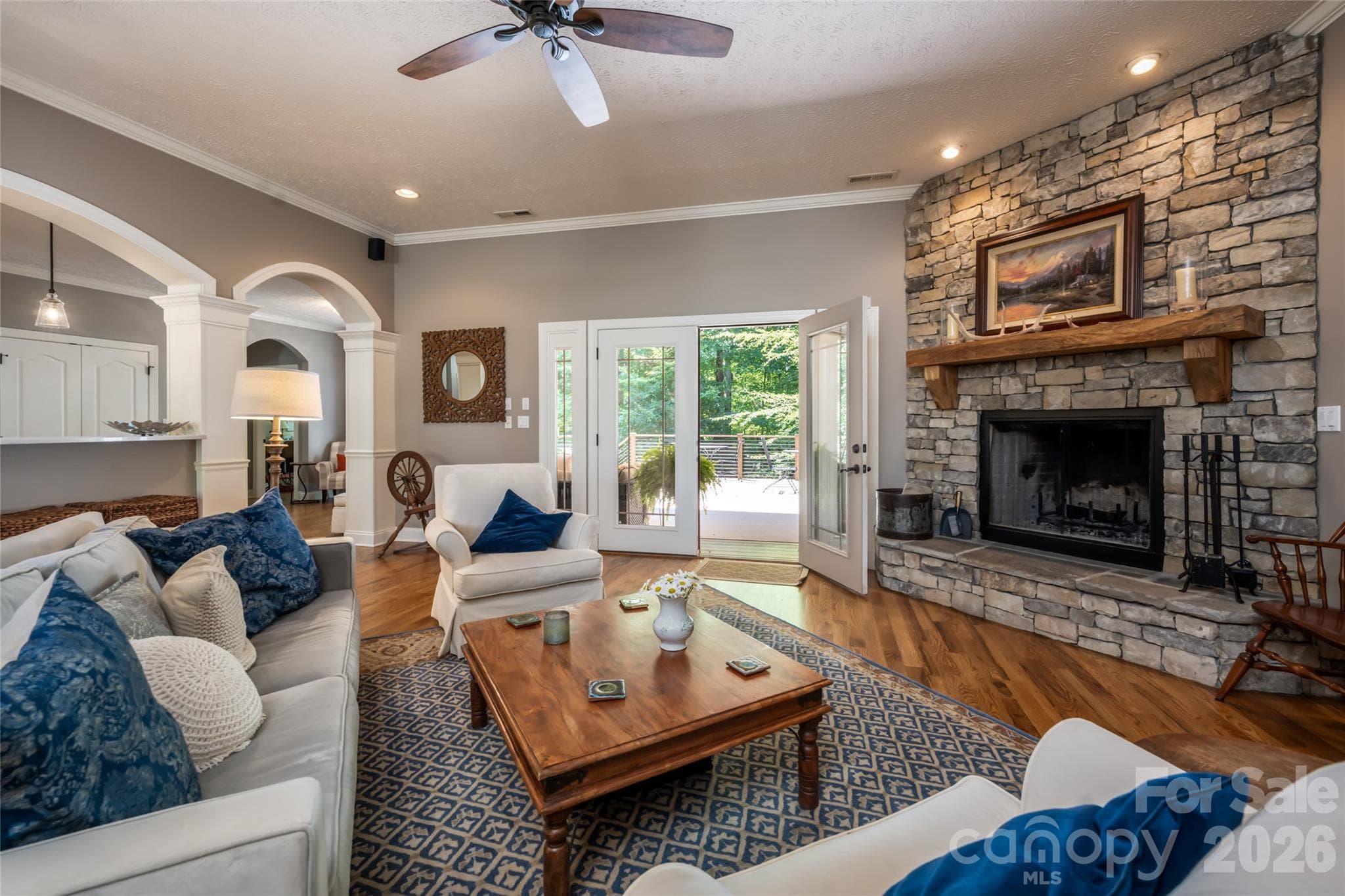 Living room with wood burning fireplace and access to upper deck through covered area - 170 Cape Martin Circle, Hendersonville