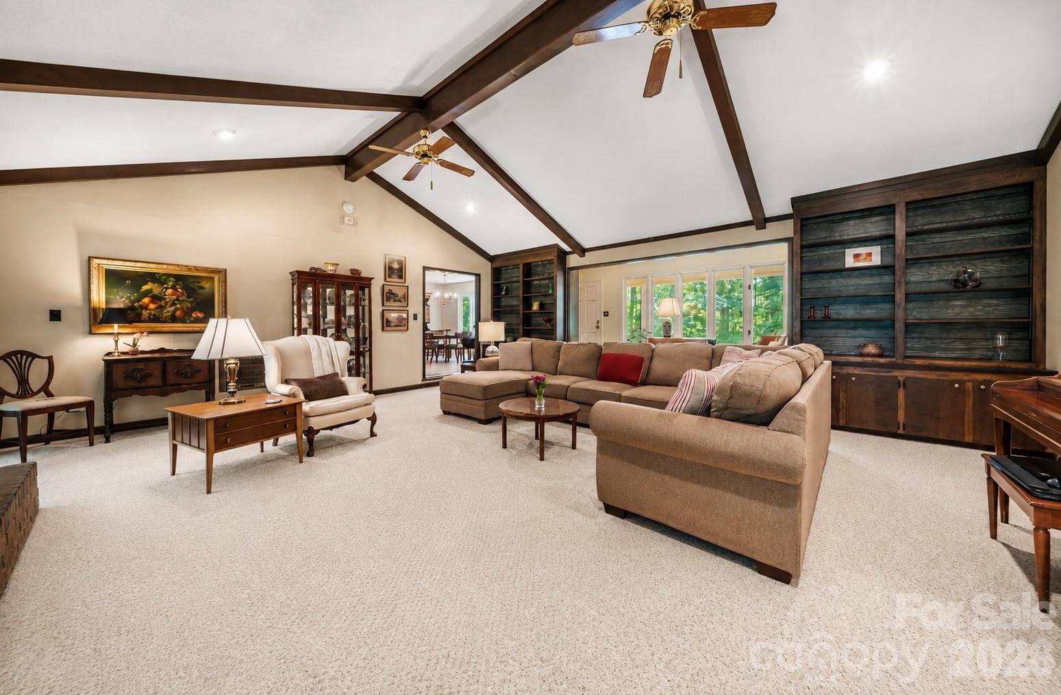 Spacious living room with built-in shelving and natural light - 3426 Driftwood Drive, Gastonia