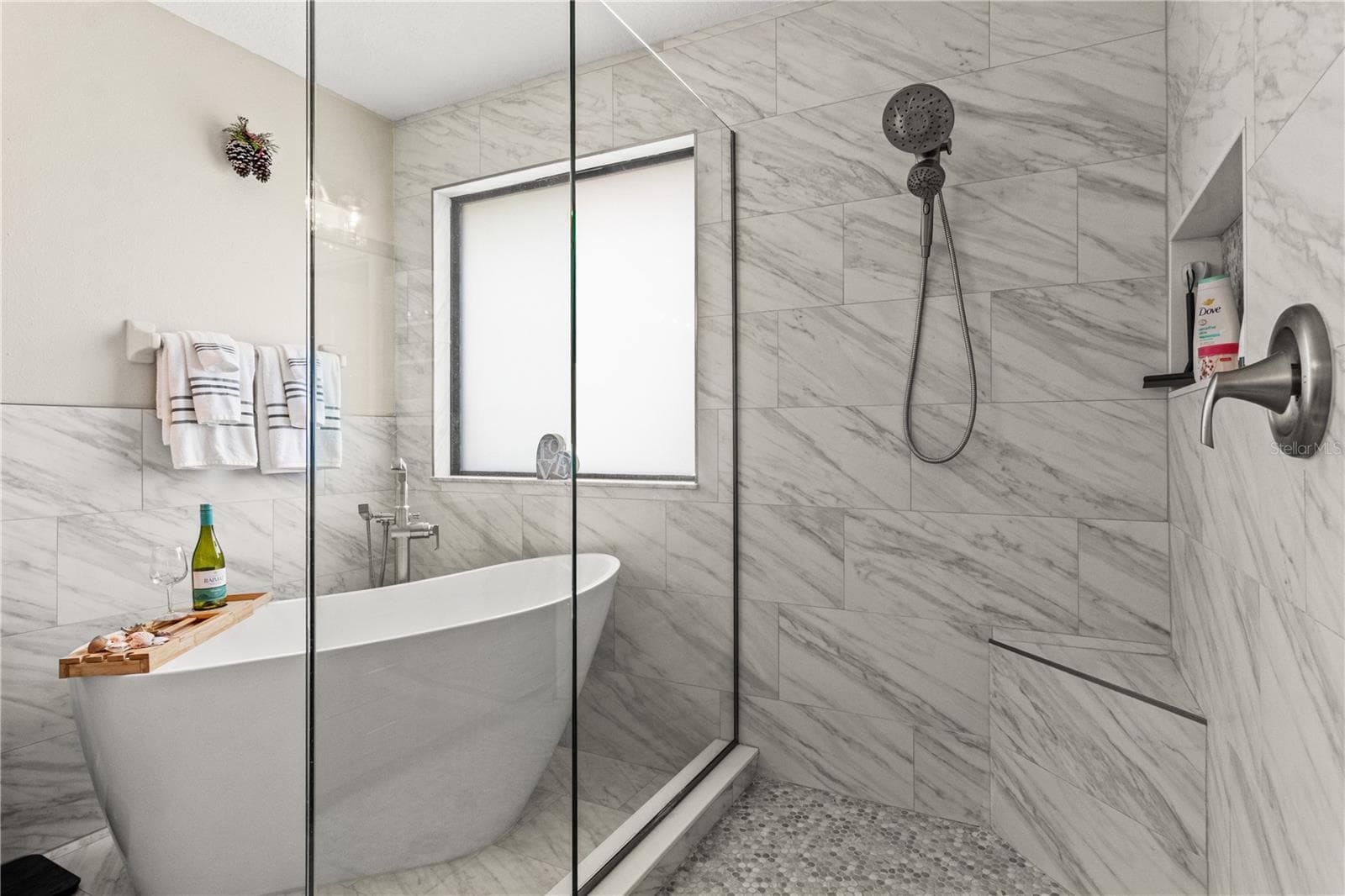The en suite bathroom has a luxury soaking tup and a beautiful remodeled shower - 5824 FISH CROW PL, LAND O LAKES