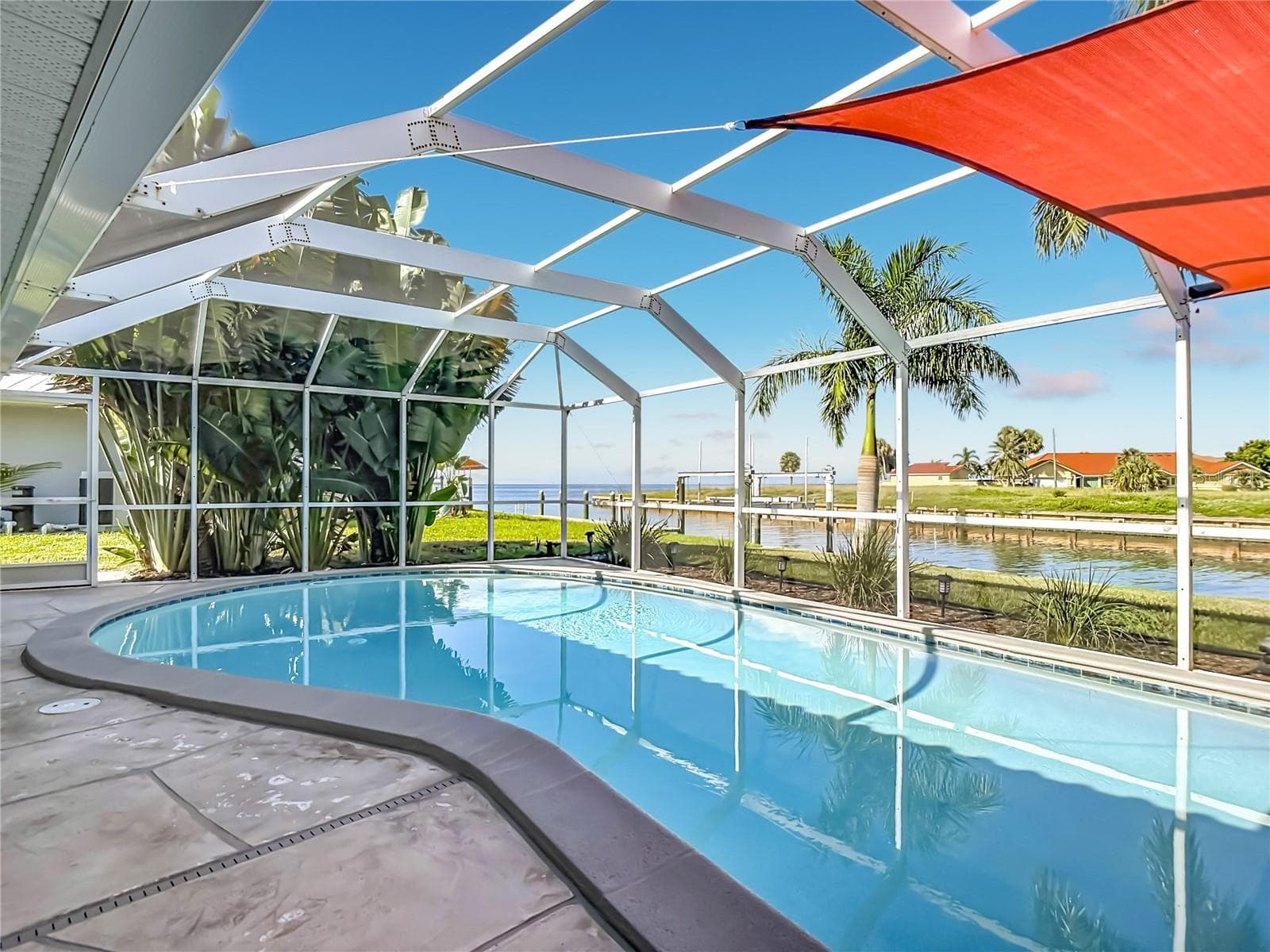Screened Pool – Spacious screened in-ground pool and pool deck offering a private outdoor area for relaxing and entertaining. - 4449 CREWS CT, PORT CHARLOTTE