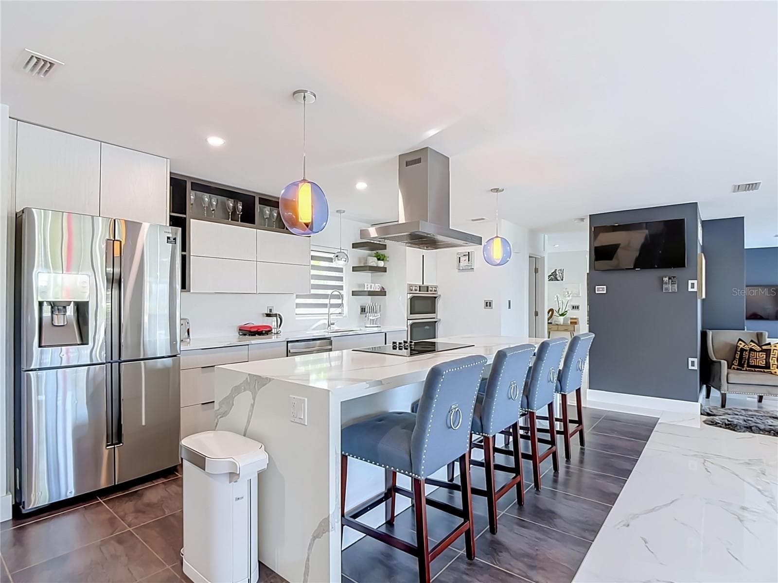 Kitchen – Modern kitchen featuring stainless-steel appliances, generous counter space, contemporary cabinetry, and island seating. - 4449 CREWS CT, PORT CHARLOTTE