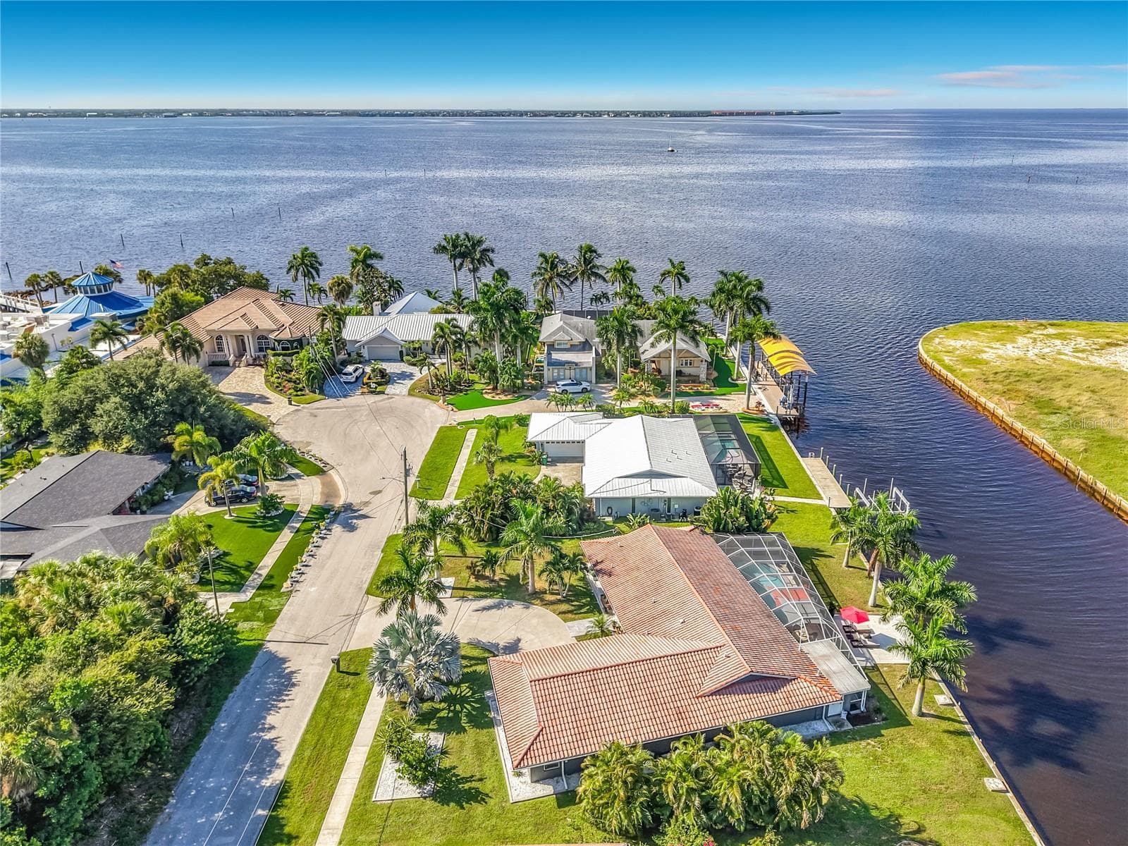 Aerial Neighborhood View – Expansive aerial view showcasing the home, canal-front neighborhood, and surrounding waterways. - 4449 CREWS CT, PORT CHARLOTTE