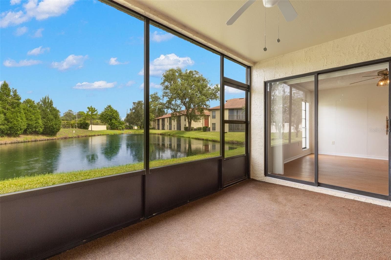 Screened in lanai with pond views - 1801 E LAKE RD #19D, PALM HARBOR